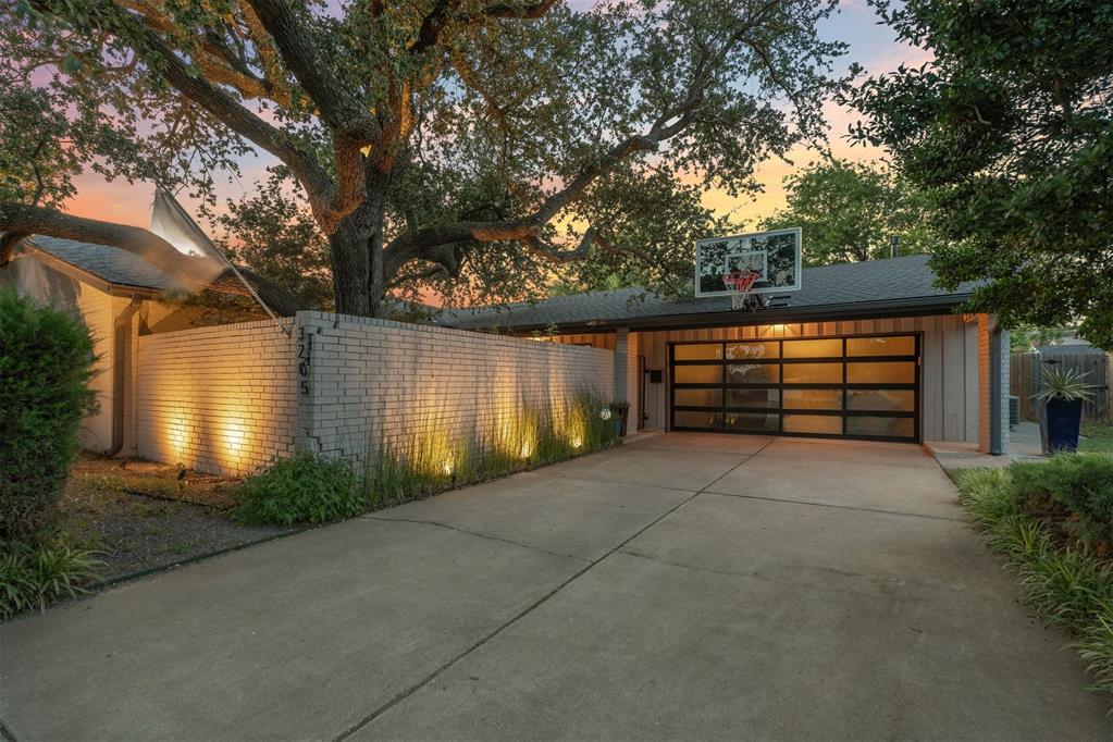 Stylish and beautifully updated, this mid-century modern gem is perfectly located close to Nichols Hills, Lake Hefner, parks, dining, and shopping. Blending classic architecture with warm transitional design, the home offers a seamless mix of character, comfort, and convenience. Elegant travertine floors with natural marbling flow throughout the main living spaces, while vaulted ceilings and rich wood accents add warmth and architectural interest. The open layout is bright and inviting, ideal for both entertaining and everyday living. Anchored by a striking fireplace with minimalist, earthy appeal, the living and dining areas connect effortlessly to a serene, landscaped backyard through large sliding glass doors. The kitchen is both functional and stylish, featuring granite countertops, stainless steel appliances, and an island for casual dining.The luxurious primary suite includes a workout room, a large custom closet, and a spa-like bath with heated floors, soaking tub, separate shower, and double vanities. A secondary bedroom features an en suite bath and private courtyard entrance, while the third bedroom, third full bath and a versatile study (optional fourth bedroom) provide generous space and charm. Additional features include a glass-enclosed sitting room, designer finishes throughout, and thoughtfully curated updates that honor the home's mid-century roots while elevating modern comfort. This is your opportunity to own a move-in ready, design rich home in the heart of NW OKC.