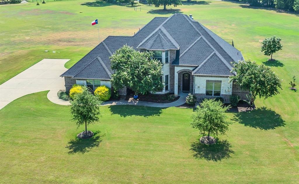 Luxury Custom Home on 2.7 Acres with Pool in The Peninsula on Lake Granbury!
Welcome to this stunning Roy Kelley custom built home nestled on 2.7 beautifully landscaped acres in the highly sought after gated community. From the moment you arrive, you'll be captivated by exceptional craftsmanship, upscale finishes, and thoughtful design throughout.
The gourmet kitchen is a showstopper, featuring a large island with recently added stone, granite countertops, custom cabinetry, double ovens, a gas cooktop, built-in refrigerator, and high-end lighting.  All flooring on the 2nd level as well as the staircase was recently replaced.
Enjoy modern comfort with energy efficient foam encapsulated insulation, a 3 zone HVAC system, 85-gallon water heater, temperature controlled walk in attic and a recently replaced Class 4 impact resistant roof. The oversized garage includes a temperature controlled, insulated shop, that is perfect for hobbies, art, or a home studio. The spacious primary suite offers a serene retreat with a spa inspired bath, and a massive walk-in closet. 
Step outside to your private backyard paradise complete with a covered patio, built in outdoor kitchen, and a refreshing pool, all surrounded by a full irrigation system and lush landscaping.  Located just minutes from the historic Granbury Square and outside city limits for lower taxes, this is your opportunity to enjoy upscale living in a private, peaceful setting with access to a community dock and boat ramp.