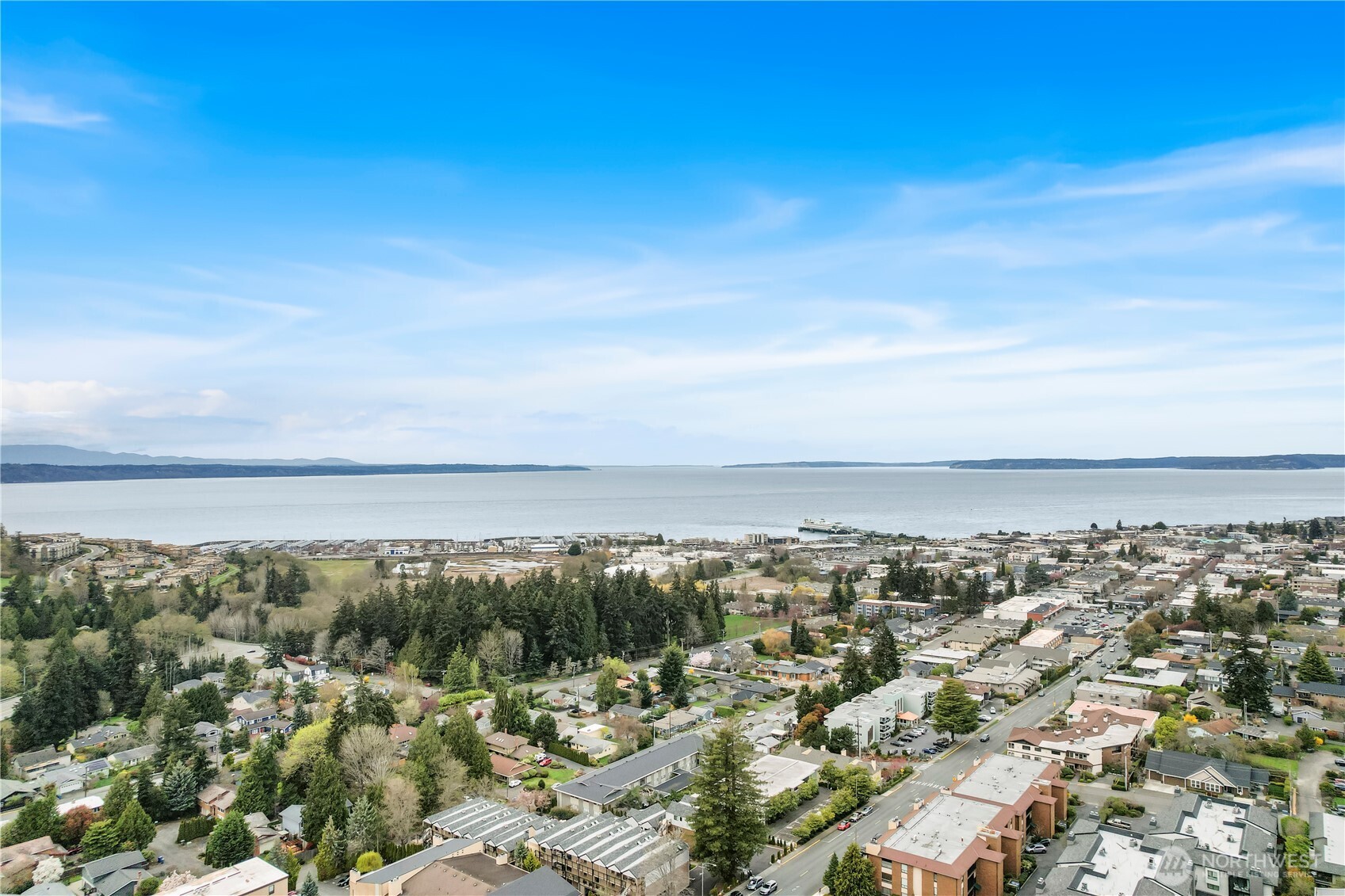 Enjoy the Edmonds Bowl lifestyle in this terrific top floor condominium with a PRIVATE OWNER'S GARAGE & fantastic south facing Sunlight! Remodeled w/ LVP Flooring, a very roomy living room w/ a fireplace, rare vaulted ceilings, a sizable sun deck/office. Spacious bedroom & 1 bathroom. Open kitchen with dining area, skylight, quartzite countertops with gorgeous cabinets and a glass tile backsplash. ALL utilities except Electrical included in HOA dues; Water, Sewer, Trash & Recycling. In addition, Shamrock Plaza has a large common recreation room with a sauna and plenty of extra parking! Renovated lobby & new elevator. Instant access to everything Edmonds has to offer including shops, restaurants, beaches, ferry & Waterfront Center!