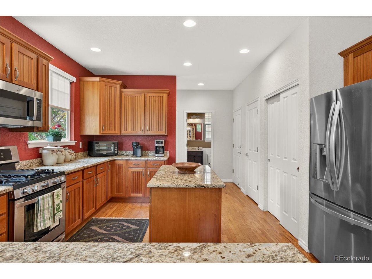 Fantastic Highlands Ranch 2-story in the highly desirable Firelight community, just steps from Firelight Park and with easy access to Highlands Ranch rec centers, shopping, dining, and everyday amenities. This charming Craftsman-style home welcomes you with a classic covered front porch and mature trees that create warm curb appeal. Inside, the bright and cheerful open layout is designed for both comfortable living and easy entertaining. Rich hardwood floors unite the main level, while soaring two-story ceilings and a cozy fireplace make the living room feel both grand and inviting. The spacious dining area and kitchen flow seamlessly together, creating the perfect gathering space. Home chefs will appreciate the warm wood Craftsman cabinetry, sleek granite countertops, pantry, gas range, and center island ideal for meal prep and casual dining. A convenient built-in office space tucked behind the kitchen offers the perfect spot for working from home, homework, or organization. Upstairs, a charming Juliette balcony overlooks the living room below and adds to the home's open feel. Three upper-level bedrooms include a spacious primary retreat complete with a luxurious 5-piece en-suite bath and a large walk-in closet. Step outside to the private backyard, ready for summer in Colorado with a large Trex deck and retractable awning for comfortable outdoor entertaining and relaxation. The Firelight community offers wonderful amenities including parks, walking trails, and a community pool, while nearby Chatfield State Park provides endless opportunities for outdoor recreation. Move-in-ready and ideally located, this is a true Highlands Ranch gem.