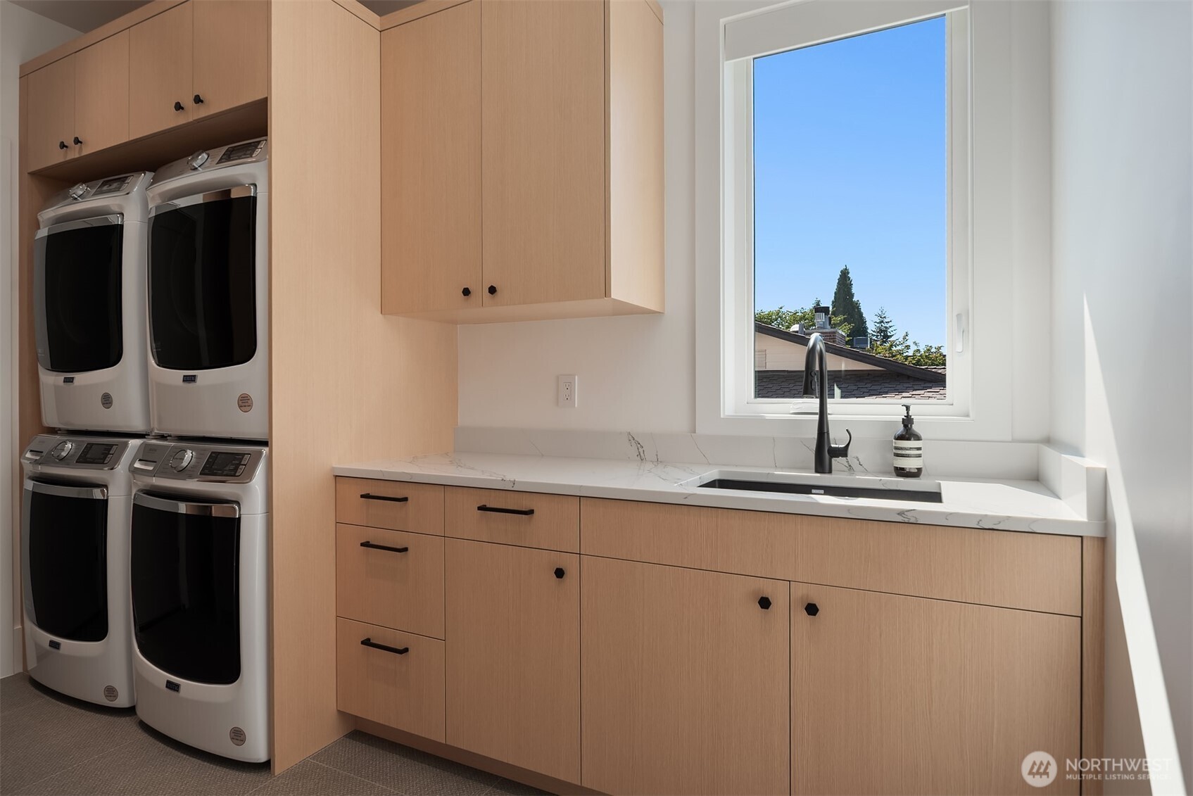 Laundry room with stacked washer and dryer