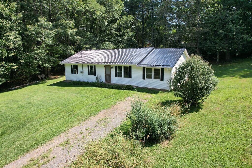 Located in the established Sherwood Forest neighborhood just outside the Hillsville town limits, this 3-bedroom, 1-bath home offers 1,248 square feet of comfortable main-level living. Recent improvements include new interior paint, a new metal roof, spray-in insulation in the crawl space, and a new vapor barrier. Laminate flooring adds to the easy, low-maintenance living. The property consists of two lots, with the second lot being wooded and offering additional privacy and the potential for a future building site, with county water available. A great opportunity for a first-time homeowner, someone looking to downsize, or anyone wanting a cozy place to call home. Enjoy the peaceful mountain setting while still being conveniently located just minutes from Hillsville, I-77, and I-81.