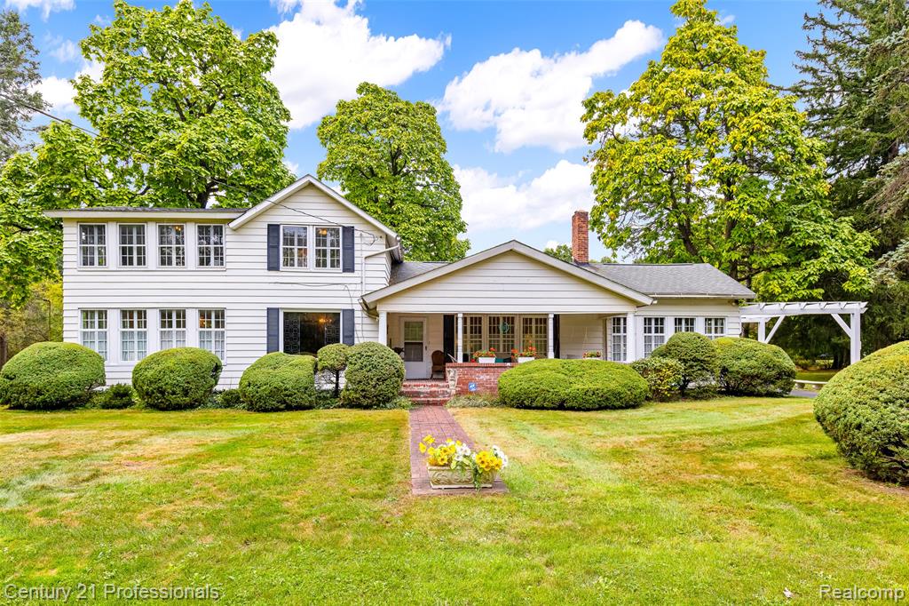 Beautiful farmhouse perfectly blends classic character with modern comfort on just over three scenic acres. The property includes a charming barn with stalls, water, electricity, and a durable metal roof—ideal for hobbies, storage, or small-scale farming. There’s plenty of open land for raising chickens, goats, or even a few cows, along with space to create your own vegetable garden or hobby vineyard.

A fully renovated secondary home sits on its own tax ID and is currently rented for $1,400 per month, providing steady income that a buyer can use toward financing or enjoy as an investment. Because the parcels are already legally split, the second home could also be sold separately in the future if desired.

Inside the main home, the first-floor primary suite is wrapped in windows on three sides, filling the space with natural light and peaceful views of trees and open meadow. Throughout the home, you’ll find rich wood floors, vintage fixtures, and built-ins that showcase timeless craftsmanship. The spacious dining room comfortably accommodates gatherings, while the bright four-season room offers a cozy space to relax year-round.

Outdoor living shines here with an expansive deck and a covered brick-floor front porch that invite you to enjoy morning coffee, evening sunsets, or gatherings with family and friends. A private basketball court adds a fun and unexpected touch.

Located within walking distance of Springfield Plains Elementary and just five minutes from downtown Clarkston, this property combines the quiet charm of country living with modern convenience. With multiple structures, income potential, and room to live, grow, and create, it’s a rare opportunity for multi-generational living, investment, or your own private homestead in one of Clarkston’s most desirable areas.