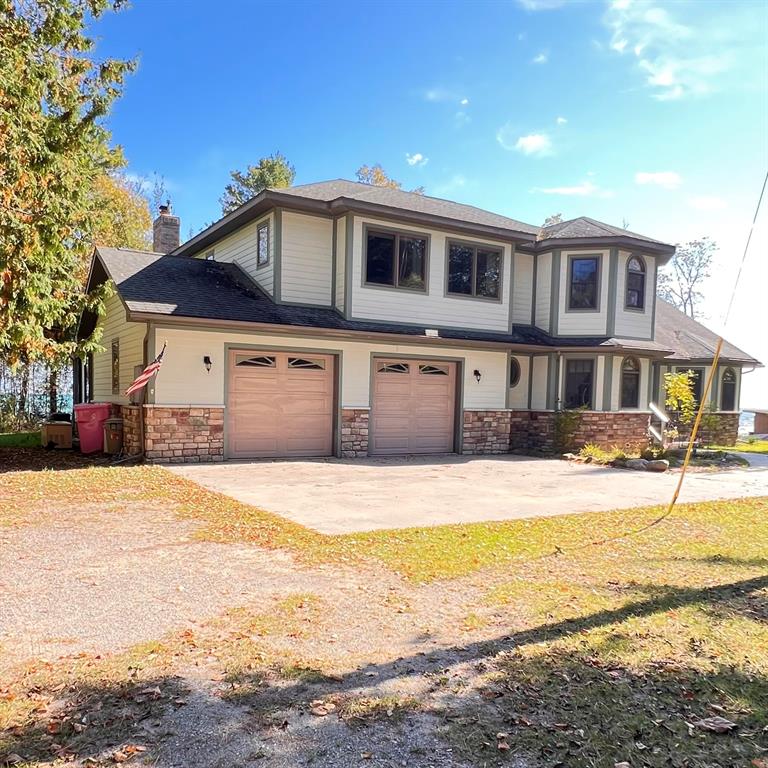 Wake up to the sounds of waves and endless views on the sunny side with this private waterfront estate featuring 185 feet of Lake Huron frontage .  The estate underwent extensive reconstruction and design changes in 2005 tripling the square footage to 4000+/-.  There is a 110'' foot enclosed 3 season wrap around porch over looking the lake.  The main entrance has a 2 story foyer.  The main floor has ample room for entertaining, there is also a natural fire place in living room and a gas stove in bedroom.  The 3rd floor incorporates a dramatic luxurious ceiling hights. The primary suite has a private porch  and a gas fireplace.  There remains a few unfinished areas that are roughed in, insulated, wired and ready to add your finishing touches.   The owner has left a large dense stand of trees for those who enjoy their privacy.  Make sure you check out the virtual tour and call today for a private showing.