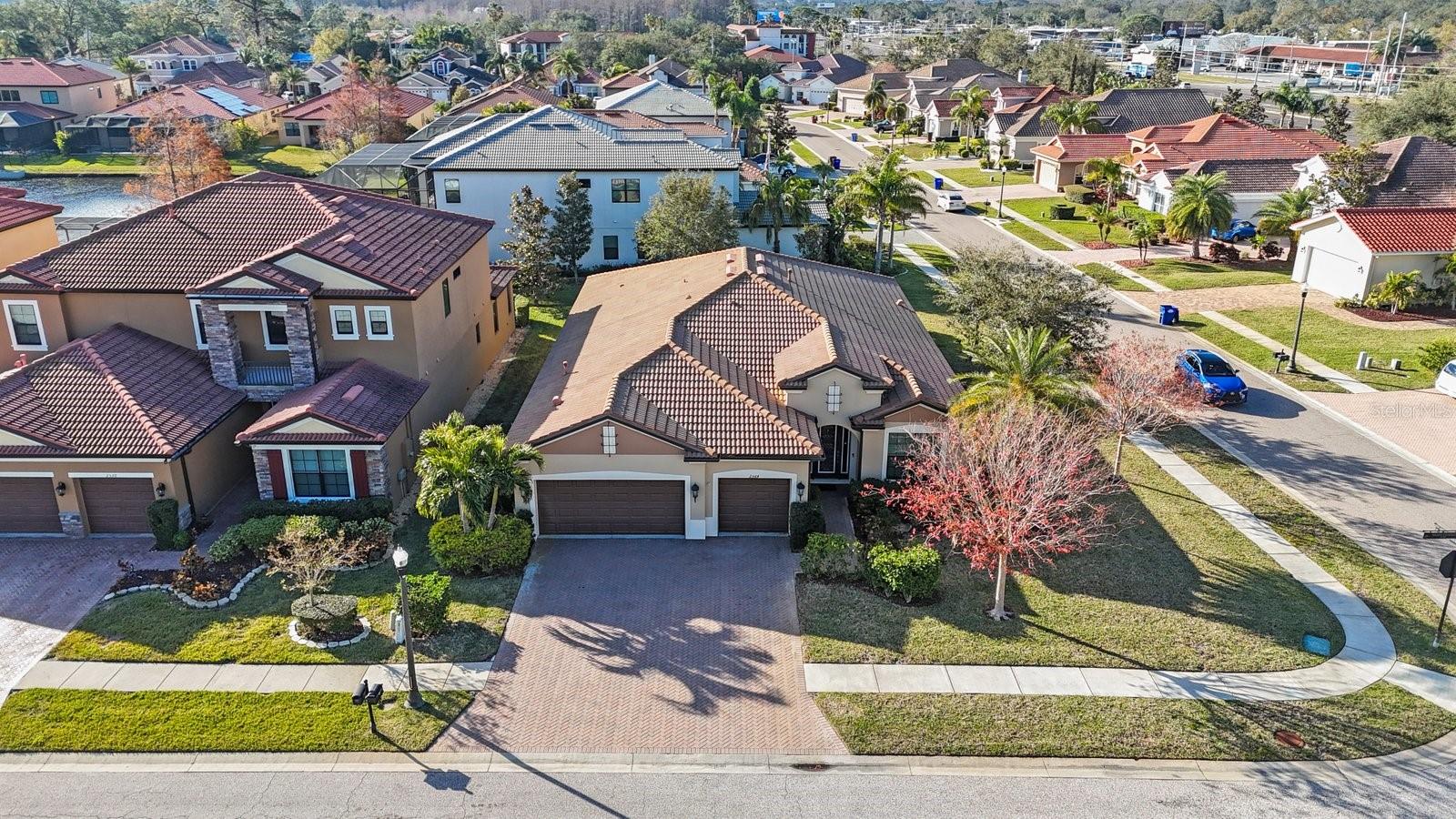 Welcome to your dream 3 bedroom PLUS OFFICE home nestled in Grand Cypress on Lake Tarpon, a serene gated community, offering the perfect blend of functionality, luxury, and timeless style. This charming abode in a NON FLOOD ZONE boasts a spacious layout with an open floor plan, creating an inviting ambiance ideal for both family living and entertaining. Curb appeal draws you in with a beautiful paver driveway and lush landscaping. Then you open the front door into a spacious foyer which leads to the heart of the home, where the living area seamlessly flows into the dining room and kitchen, providing a versatile space for gatherings and relaxation. The chef's kitchen is a standout feature, boasting stainless steel appliances, a double oven, a built-in wine rack, and gas cooking for precision and ease. A butler’s pantry and a walk-in pantry provide ample storage space, making it perfect for entertaining and everyday living. Enjoy casual meals at the breakfast bar or in the nook…you have both! The dining room is large enough for a crowd or small enough for an intimate dinner, and features a tray ceiling. The heart of the living space is the inviting fireplace, adorned with stunning new Italian marble, offering both warmth and elegance. A cozy desk area is tucked into the corner of the great room, keeping the family connected. Step outside to the charming lanai through sparkling sliding doors in the great room, and relax in the hot tub as you enjoy backyard views. After a long day, retreat to the primary bedroom suite which includes a sitting/workout area, a 12x12 walk in closet with organizers and a stunning bath with double sinks in a stylish vanity, a soaking tub, a stellar stall shower and a separate water closet. The split bedroom plan provides privacy and flexibility, catering to a variety of lifestyles. The two additional bedrooms are spacious and accomodating and share an attractive bathroom. A generous office at the front of the home is accessible through French doors, offering both privacy and functionality. Pass thru the mud room into the Laundry room, making laundry day a breeze! The roomy laundry room also features a laundry sink for convenience, and shelves for storage. An adorable half bath completes the inside! Step outside to a nice fenced yard with a firepit to enjoy on chilly evenings.  With a three-car garage providing ample parking and storage space, along with a water softener and amenities and access to Lake Tarpon, this home is perfect for any family. But the perks of this home don't end there. This home offers a brand new Hot Water Heater, new coils on the A/C, a newer dishwasher, washer and dryer, and microwave, new gutters installed, a newer hot tub, and a freshly painted exterior and interior. All this, and a fabulous location close to shopping, beaches, fine dining, world class golf, and just 30 minutes to Tampa International airport.  Add the proximity to downtown Tarpon Springs and our famous Sponge Docks, and this home has it all!