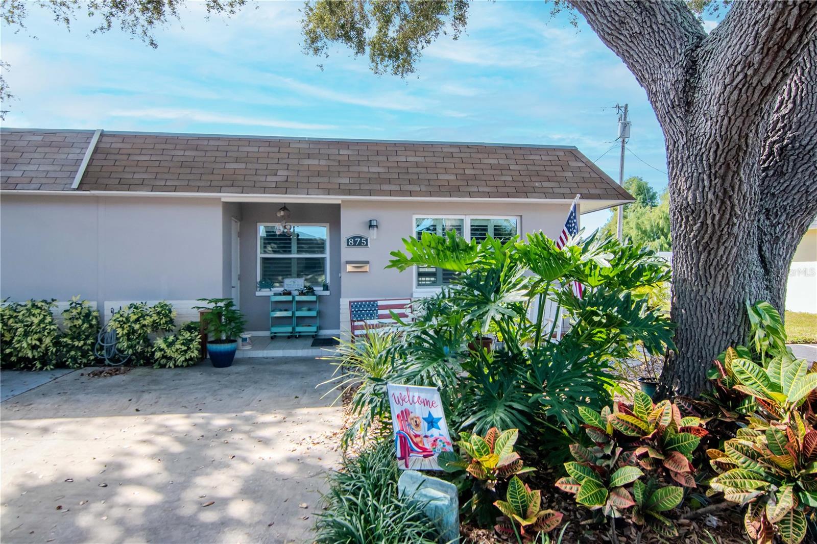 Welcome to Skye Loch Villas in the heart of Dunedin. This bright and beautifully remodeled end-unit villa offers one bedroom, one bath, and a spacious 200 sq. ft. fully enclosed lanai, the true highlight of the home. With floor-to-ceiling sliding windows, custom room-darkening shades, and tile flooring, this versatile space is perfect for morning coffee, relaxing afternoons, or evening gatherings while enjoying the Florida breeze.  Inside, you’ll find thoughtful updates throughout, including tile floors, granite countertops, new kitchen cabinetry (2025), plantation shutters on all windows, and stainless steel appliances. The kitchen also features a farmhouse sink and a new refrigerator. The open, eat-in layout connects easily to the living area, where large windows provide serene views of the Skye Loch pond. Additional recent upgrades include a foam roof, energy-efficient windows, a 2-ton A/C system, and updated plumbing and electrical (2021), giving you peace of mind for years to come. The villa also includes a convenient stackable washer and dryer hookup. Set within a friendly 55+ community, residents enjoy access to a heated pool, clubhouse with kitchen, library, shuffleboard courts, and regular social events. The low $300 monthly HOA covers water, sewer, trash, premiere spectrum cable and internet, lawn care, and exterior paint, offering truly maintenance-free living. Located walking distance to downtown Dunedin’s Main Street, you can enjoy dining, shopping, and breathtaking sunsets at the marina or along the scenic Gulf trail. Just minutes from Honeymoon Island, Clearwater Beach, and the Pinellas Trail, this move-in-ready villa combines comfort, quality, and an unbeatable lifestyle.