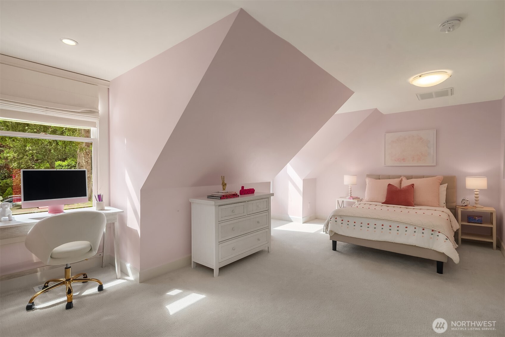 Whimsical pink bedroom with a build-in desk nook
