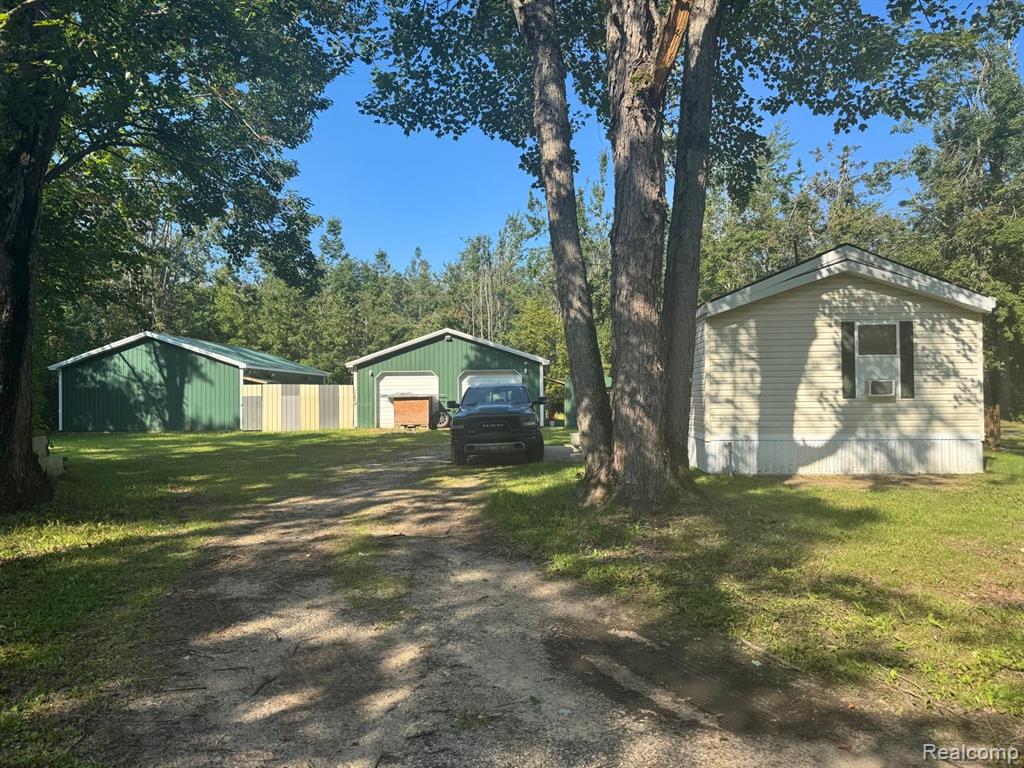 Move-in ready manufactured home set on 5 beautiful acres! This property offers plenty of space inside and out, featuring a spacious garage and a large pole barn for extra storage or hobbies. A great opportunity to enjoy country living.