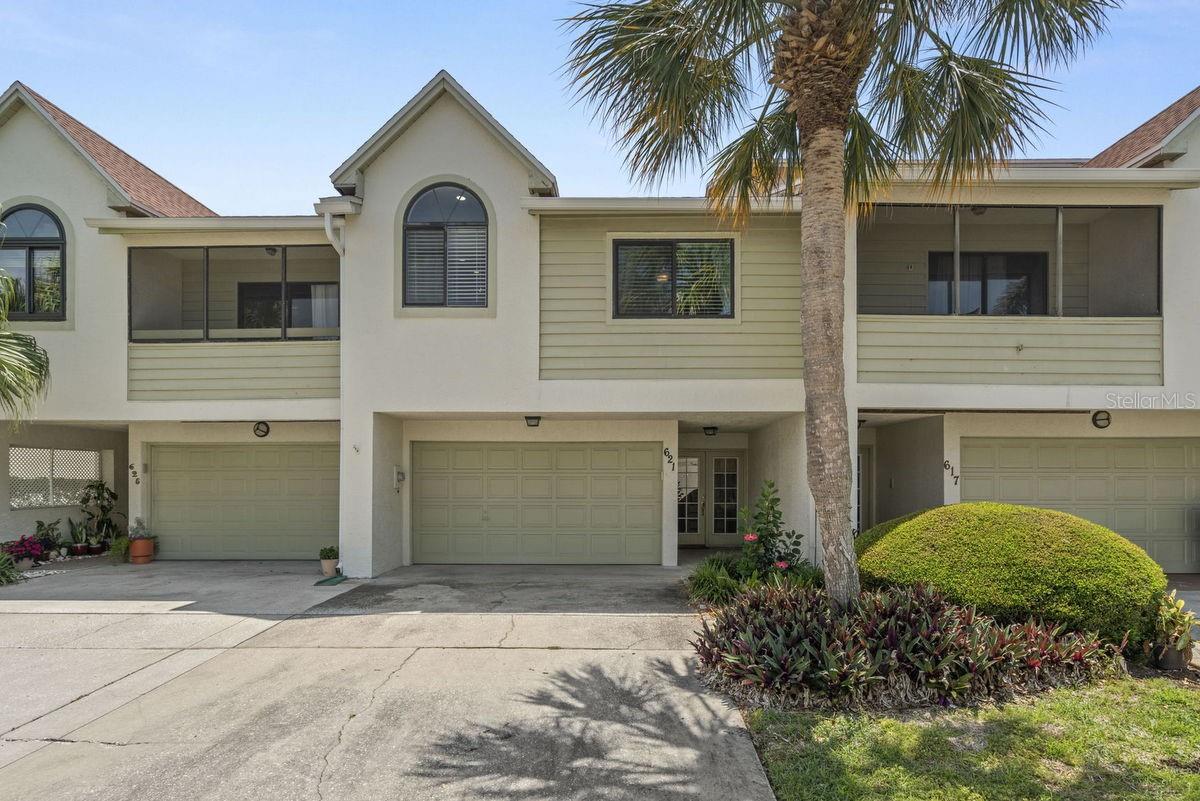 This incredible property is PERFECT for those seeking to be footsteps from an active & vibrant lifestyle. It is a tastefully updated townhome in a waterfront community, PLUS it comes with a deeded BOAT SLIP. Adjacent to the property is the 75-mile Pinellas Bike & Jogging trail, and less than a mile away is the recently updated Dunedin Golf Course and Clubhouse. A short bike ride north are the sandy beaches of the Dunedin Causeway & Honeymoon Island, and a short ride south are several parks, eateries, watering holes, and Historic Downtown Dunedin with its unique shops, top rated restaurants, and endless activities. Live where others vacation! Wake up early, grab your fishing rod and take a short boat ride to the Gulf of Mexico for a day of fishing & leisure, or grab some friends for a quick trip to Honeymoon, Caladesi, or Three Rooker Island to watch the sunset! The property itself is decorated in a beach cottage theme and features a covered front porch, plus relaxing 1st & 2nd floor screened porches overlooking open green spaces and majestic trees. It does not back up to other townhomes! Both porches are ideal for your morning coffee and evening glass of wine. Upon entering the home, a bright foyer and stairwell lead to the main floor where you're greeted by soaring ceilings and open living, dining, and kitchen spaces that radiate care and inspire entertaining. A wood burning fireplace gives the space a touch of nostalgia. The main floor was recently re-designed & renovated to include master AND guest suites, BOTH with private full baths... Plus a NEW half bath. The ground floor has a finished bonus room that can be used as a 3rd bedroom or family room, along with an oversized 2-car garage. The home also features the following updates, KITCHEN: shaker cabinets with hardware, granite counters, backsplash, stainless farm sink, faucet, and stainless steel appliances, MASTER & GUEST BATHS: vanities, stone counters, faucets, mirrors, showerheads, and custom tiled walk-in showers with benches & glass enclosures, INTERIOR: recessed lights, ceiling fans, light fixtures, 6-panel doors with hardware, and water heater (2020), EXTERIOR: shingle roof (2019), PLUS hurricane impact windows, doors, and glass sliders (2019). Curlew Landings is a beautifully maintained, pet friendly, waterfront community with heated pool & spa. Maintenance fees include almost everything but electric. At the community entrance, there’s a Jolley Trolley stop which runs from Clearwater Beach up to Tarpon Springs. Also enjoy the countless amenities Dunedin offers: beaches, parks, casual & fine dining, roof top bars, micro-breweries, cafes, bike riding, boating, fishing, downtown festivals, concerts, art shows, spring training baseball, championship golf, sunsets, and events at the Community & Fine Art Centers. PLEASE NOTE: This unit did NOT have any water intrusion during Helene & Milton! For those that may have interest, furniture is negotiable. This is a definite Must See for boating enthusiasts seeking an affordable, move-in ready home with an active & vibrant lifestyle this property conveys.