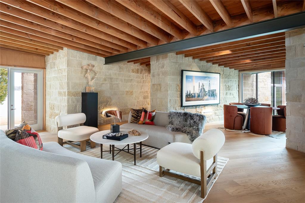 Designed by Josh Nimmo and Built by Greenwell Homes. Introducing 12590 Sea Island at Long Cove Cedar Creek Lake. A significant architectural statement on .77 acres, this newly constructed, single-level residence embodies elevated lake living through design, scale, and intention. Designed as a true art home, the architecture balances stone walls, warm beams, and expansive walls of glass that frame uninterrupted lake views, approximately 227ft of water frontage.Multiple living rooms unfold with effortless flow, creating distinct yet connected spaces for gathering and entertaining. A dedicated billiards room with a built-in bar adds a refined layer of leisure, while the open-concept design allows light and landscape to permeate every corner of the home.The thoughtfully designed one-level layout includes two private primary en-suites, offering both luxury and flexibility for owners and guests alike. Seamless indoor-outdoor transitions invite the water into daily life, blurring the line between retreat and residence. 12590 Sea Island is not simply a lake house — it is a curated architectural experience on Cedar Creek Lake, move-in ready and uncompromising in its execution.