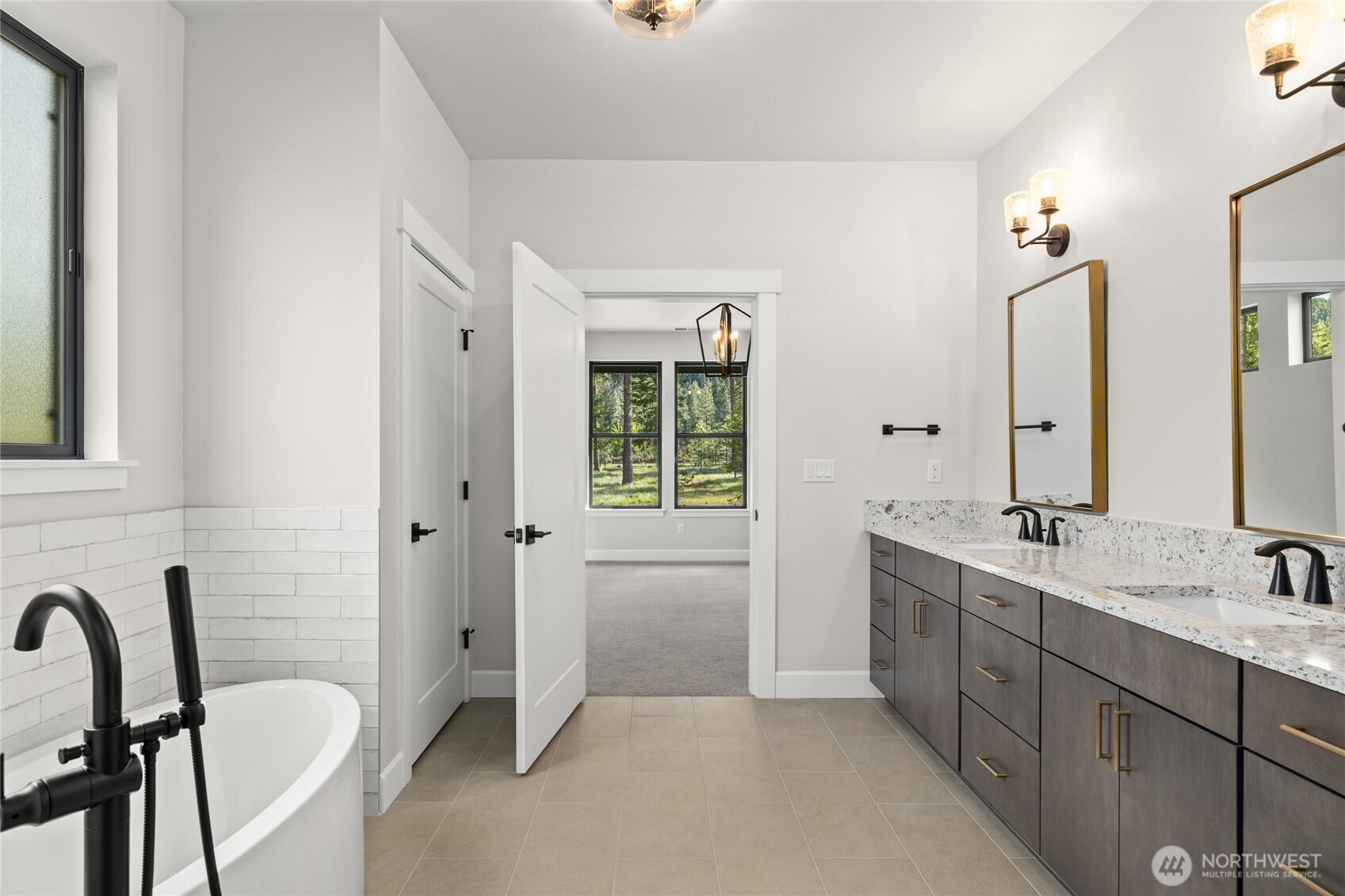 Five piece primary bath featuring solid countertops with undermount sinks.