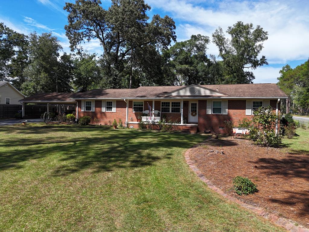 Take a look at this CLASSIC brick house in Thomasville, GA! This 3BR/2Bath home in a wonderful neighborhood on Trailwood Drive has it all! Check out the nice sunken den with great built-in cabinets and shelf space! PERFECT for movie night or arts and crafts. No more ordering out!You will want to cook EVERY meal in this huge kitchen, complete with hard surface countertops and lovely cabinetry. There is a formal dining and living room, a primary suite with its own bathroom, and handsome original hardwood flooring throughout the home. There is a big fenced backyard, and plenty of room to park under the double carport. Call your favorite Realtor TODAY for a closer look at this classic home!