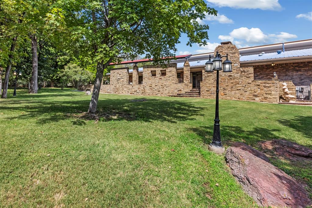 Statement Architecture in Oakdale Farms — A True 1980s Time-Capsule Estate.  Set on 1.48 acres within the gated, Oakdale Farms community, this 6,199-square-foot estate sits at the end of a quiet cul-de-sac. With 5 bedrooms and 6 full bathrooms, this postmodern residence showcases the bold geometry, dramatic rooflines, durable metal roof, and high vaulted ceilings that define its era — a home for buyers who want to make it their own rather than undo someone else's renovation.  Twelve solar tube skylights wash the interior in natural light, highlighting the home's character and generous, statement-making living spaces. A cozy fireplace inglenook adds warmth and old-world charm, while the expansive dining room comfortably accommodates a 10–12 chair table for grand-scale entertaining. A dedicated library and private office both offer a quiet retreat for reading or work. For the true home chef, a dedicated scullery extends the kitchen with an additional oven, microwave, refrigerator, and abundant cabinet storage — ideal for entertaining without disrupting the main kitchen. The oversized bonus/family space offers incredible flexibility, with enough room to house a dance studio, a mahjong tournament, or any gathering you can imagine.  Beneath the bonus space lies a full lap pool, thoughtfully closed in 2000 and left with all original equipment intact — ready to be recommissioned by the next owner who wants to bring it back to life.  Outside, enjoy a resort-style outdoor kitchen and entertainment area perfect for hosting, surrounded by a flourishing orchard of peach, apple, pear, and fig trees. Built for self-sufficiency and peace of mind, featuring a private well with filtration and reverse osmosis system, a full-home electric generator, and a basement that doubles as a storm shelter and wine cellar.  Newly added neighborhood amenity, a new double pickleball and basketball courts.  This is a rare opportunity to own a piece of architectural character and history.