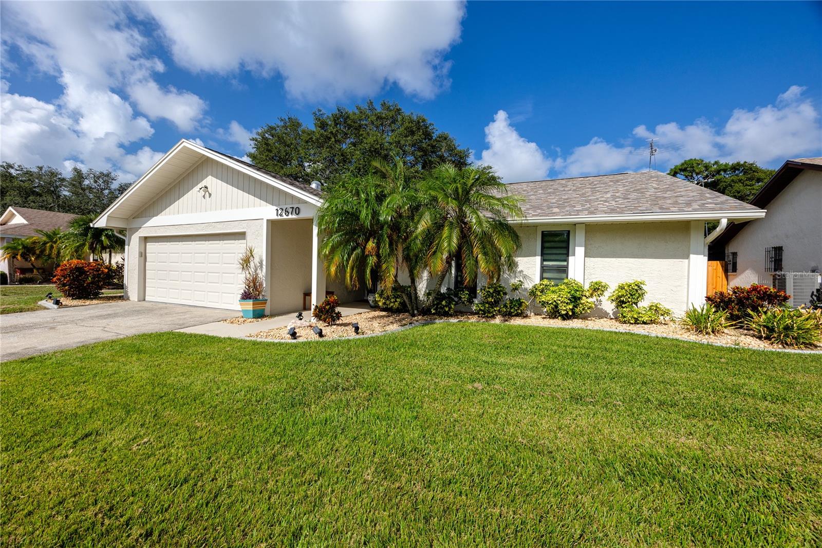 Discover a home that combines privacy, versatility, and an exceptional location. Situated on a quiet cul-de-sac, this well-maintained residence offers an inviting split-bedroom floor plan, generous living spaces, and multiple places to enjoy Florida’s indoor-outdoor lifestyle.At the center of the home is a spacious great room filled with natural light and anchored by a wood-burning fireplace, creating a welcoming setting for everything from quiet evenings to gatherings with friends. The kitchen keeps you connected to the action with a breakfast bar, solid granite countertops, and attractive solid wood cabinetry with decorative glass inserts.The private primary suite is much more than a place to unwind. Along with a walk-in closet and updated bath featuring an impressive walk-in shower, you’ll find a bonus space currently enjoyed as an artist studio. Its flexible design makes it equally suited for a home office, reading room, exercise area, or personal retreat. Sliding doors open to a patio sitting area, providing another peaceful spot to enjoy the outdoors.An interior laundry room adds everyday convenience with overhead cabinetry, a utility sink, and additional pantry storage. Numerous closets throughout the home provide even more space to keep everything organized.Out back, a large screened porch invites you to relax beneath the canopy of mature shade trees. The fenced yard offers privacy, established landscaping adds to the tranquil setting, and an automatic sprinkler system helps simplify lawn care. Best of all, with the Pinellas Trail directly behind the property, walking, biking, and exploring the area are practically at your doorstep.Enjoy a location that puts you close to Walsingham Park, Largo Mall, shopping, dining, and the beautiful Gulf beaches while still giving you a peaceful place to come home to.