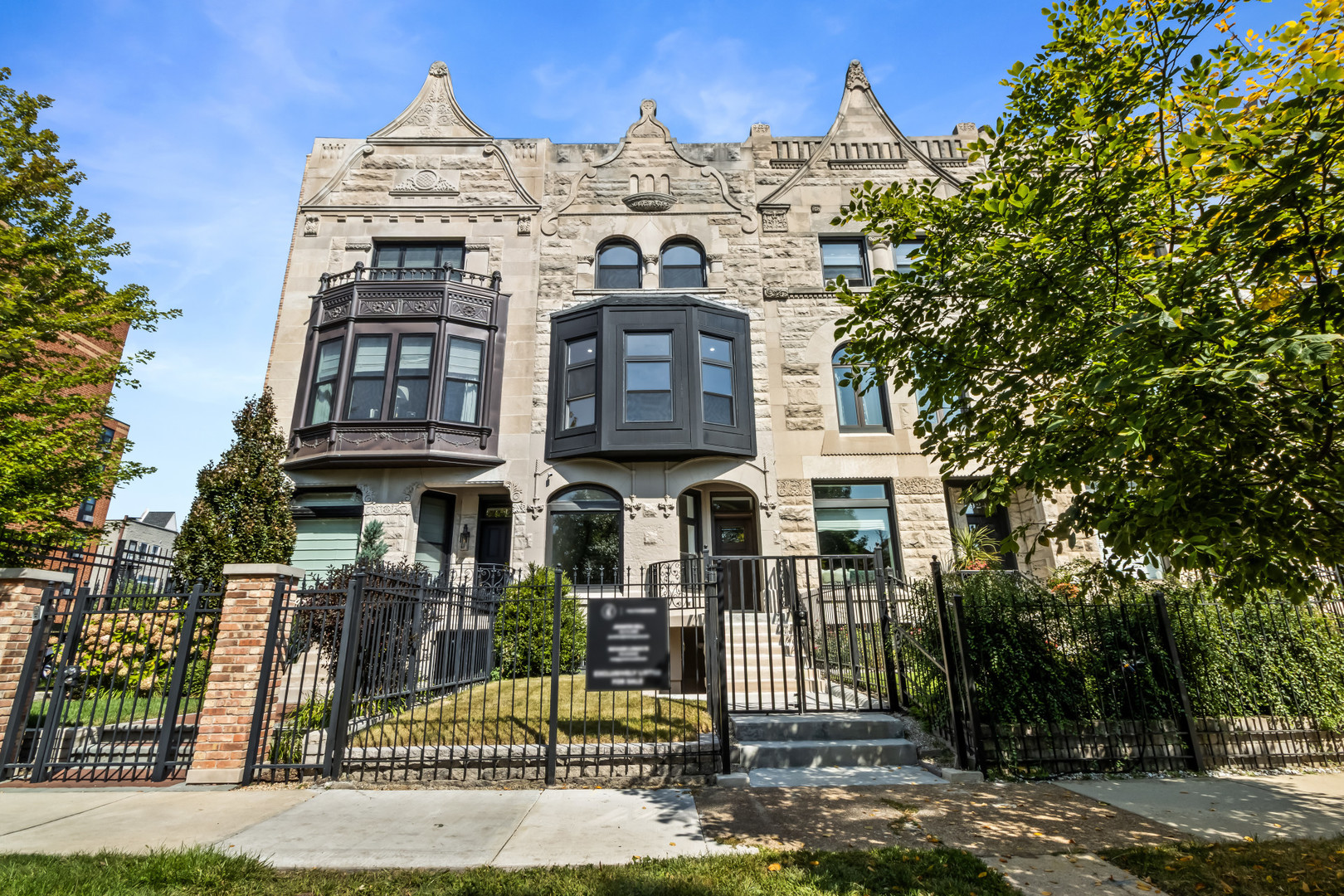 Where timeless architecture meets modern ease, this exquisitely renovated greystone offers room to live, entertain, and unwind in style. With six bedrooms, four-and-a-half baths, and a thoughtful three-level layout, every corner invites you to stay a little longer.  On the main floor, natural light flows through gracious living and dining spaces, anchored by a designer kitchen and a dining room crowned with a striking fluted light fixture-an art piece in its own right. Wide doorways lead to a rear deck that's perfect for summer dinners or a quiet morning coffee.  The second floor is a sanctuary. The primary suite features customized closets and a charming step-up window niche that begs for a built-in seat or meditation perch. An additional ensuite bedroom shares the level, while a private balcony off another bedroom offers a quiet retreat in the treetops.  Up on the third floor, the home takes a playful turn: a dedicated Snack Lounge-complete with mini fridge, microwave, and cabinetry-sits among three more bedrooms, ideal for late-night treats or weekend movie marathons.  A fully finished lower level provides a guest bedroom, flexible exercise or hobby space, and a convenient exterior entrance. Three separate furnaces deliver zoned heating and cooling for comfort on every floor. Outside, a classic one-car brick garage completes the picture.  Set on a serene, short street just blocks from the lake and the pedestrian bridge, this home blends elegance and everyday function. From the statement lighting to the inviting outdoor spaces, 922 E 42nd Place is designed for the way you live-and the way you love to entertain.