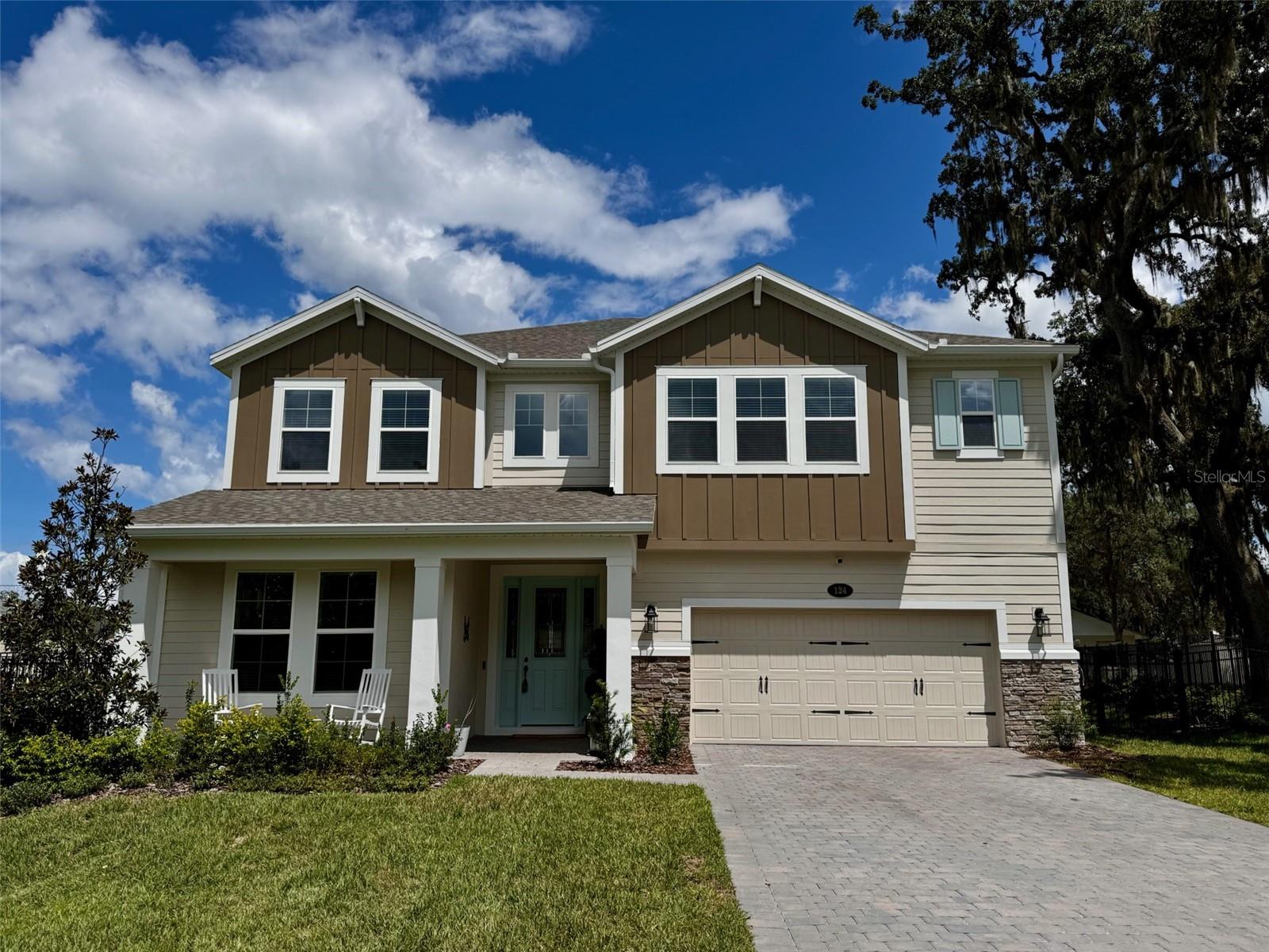 Welcome to 124 Lake Drive, a stunning two-story residence in the heart of Oviedo. Built by M/I Homes, this GreenStar certified energy efficient Glenwood model offers 3,932 square feet of thoughtfully designed living space, featuring 5 spacious bedrooms, 4 full bathrooms, and a 3-car tandem garage. Ideally located just 6 minutes from Oviedo on the Park and 7 minutes from UCF, this home on an established, quiet tree-lined street combines modern comfort with convenience. Step inside to an open-concept first floor showcasing a formal dining room, spacious family room, and a bright nook overlooking the lanai. The chef’s kitchen is the centerpiece of the home, featuring a large quartz island, a butler's pantry, an expansive walk-in pantry, and panoramic views of the living and outdoor spaces. A first-floor bedroom with an adjacent full bath and private entrance from outside, make this space perfect for a guest suite or in-law suite and adds to the home’s functionality.  Upstairs, double doors open to the oversized owner’s suite, bathed in natural light through large windows. The suite includes an enormous walk-in closet with custom built-ins and a spa-like bath. Three additional bedrooms, (two with large walk-in closets, one with an en suite bathroom)and a spacious loft provide plenty of room for family and guests. The third tandem garage space has been converted to a home gym. Outside, enjoy the nice evening breezes from the lake across the street and the fully fenced yard with plenty of room to add a pool or patio behind the home. The home also includes a newly installed Vivint home security system with outdoor cameras and indoor control panel, which can also be controlled using the Vivint app. The top A-rated Seminole County schools this home is zoned for truly can't be beat! Home is backed by M/I Homes' transferrable 10 year structural warranty. Schedule your showing today and make this recently constructed home yours!