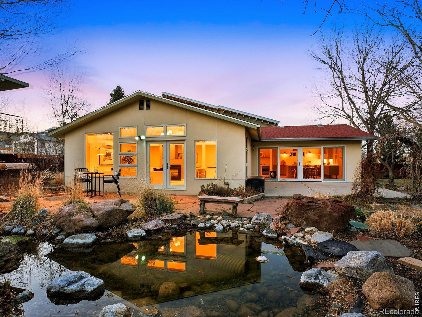 This sun-filled North Boulder contemporary presides over extraordinary private grounds. This is not your typical Boulder yard - you'll enjoy nearly a third of an acre with lush private gardens and a huge detached guest studio with radiant floor heat, a 3/4 bath, and its own private entrance. This is a home with the kind of soul that stops you in your tracks. It's a genuine sanctuary - layered gardens dense with mature plantings, a custom koi pond fed by a surface well, stone pathways through canopied shade, and sun-drenched clearings that feel miles removed from town. The scale and privacy of this fully fenced property is virtually impossible to replicate in North Boulder today.The luxury kitchen renovation is a standout, built for serious cooking and easy entertaining. Doors open directly to the patio and gardens, blurring the line between indoors and out in the way Boulder living is meant to feel. That same elevated attention carries through to the beautifully renovated primary bath and guest powder room - refined finishes and a cohesive design sensibility that make the entire home feel current without losing its warmth. Then there is the ace up this home's sleeve: the detached studio with as many uses as you have visions for it: multigenerational living done right, a home office with a twenty-step commute through the garden, or a turnkey space for guests. This kind of flexible, self-contained square footage is the feature buyers dream about but rarely find. And the location seals the deal - step off the property onto Boulder's amazing bike path network. Wonderland Lake is a short walk away too! One of the most coveted pockets of North Boulder - quiet, established, and connected - with easy access to shops, dining, Lucky's Market, and the energy that makes this part of town unlike anyplace in Boulder. LIVE BOLDER, LOVE BOULDER!