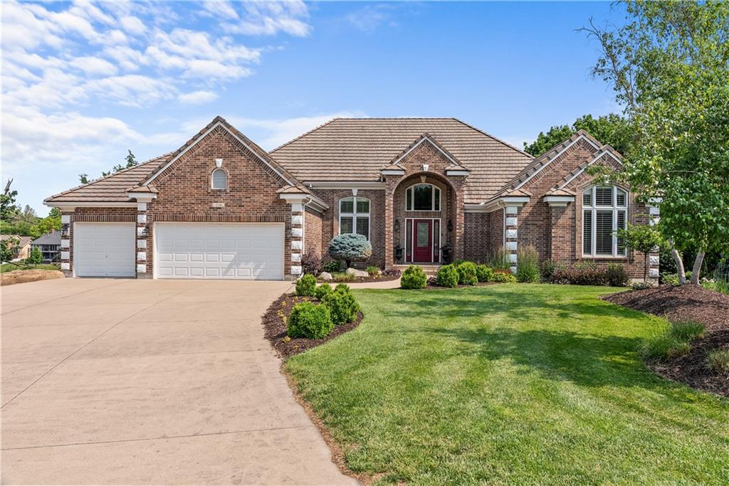 Absolutely stunning Lakefront home!  This meticulously maintained and beautifully updated Reversed 1.5 story home offers incredible lake views. The completely remodeled kitchen is both beautiful and functional--featuring custom cabinetry, deep drawers for optimal organization, a large island and a cozy breakfast nook perfectly positioned to take in the serene lake views while enjoying your morning coffee. Gorgeous wood floors flow throughout the main level. The spacious Primary suite has a spa-like bath with his and hers vanities, a custom tiled shower, soaker tub and professionally designed walkin closet.  There is a 2nd bedroom on the main floor. The curved staircase takes you down to the finished walkout lower level is built for entertaining! Featuring a large wet bar, theater room, family room and 2 additional bedrooms both with private bath access. The exterior of this home is equally stunning starting with the all brick construction, tile roof, manicured landscaping and a newly replaced composite deck. The lower level paver patio has lots of space and a tranquil water feature. This is lakefront living at its finest!