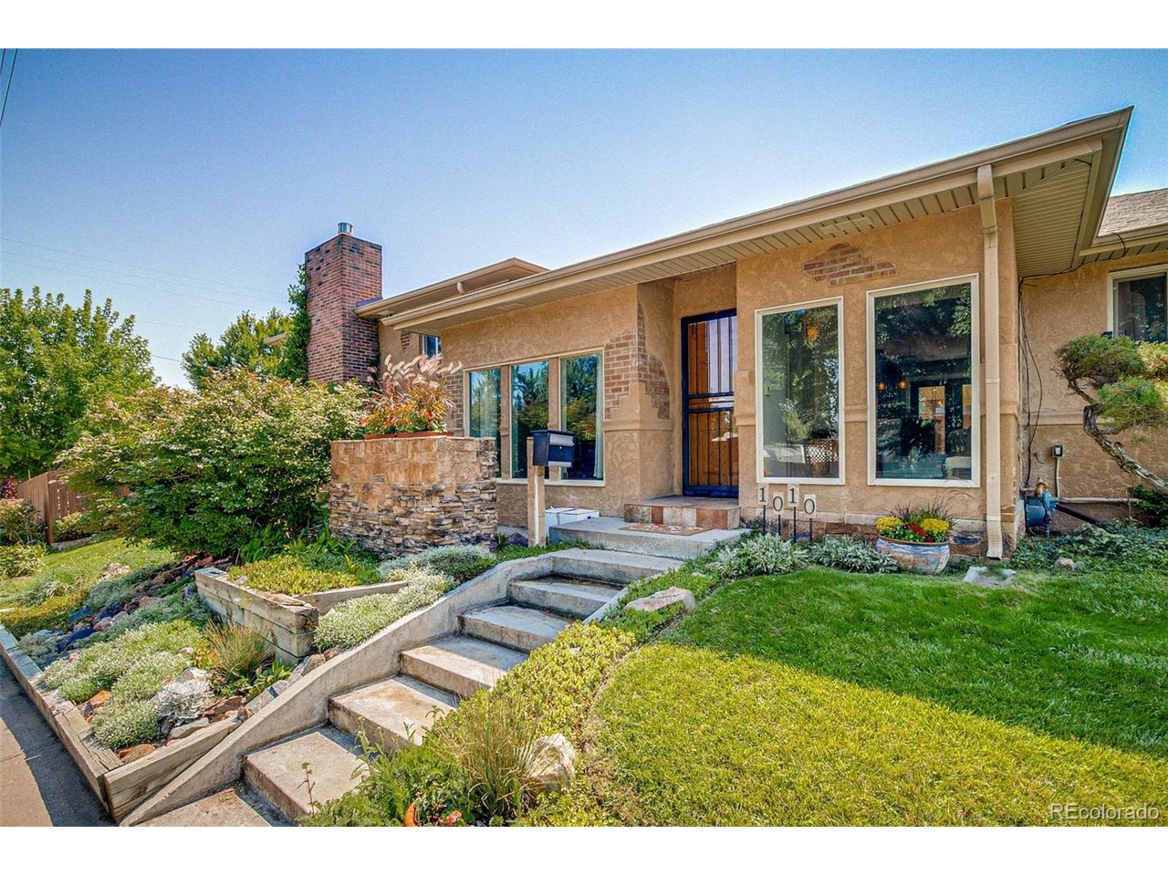 If you're looking for space, flexibility and a great Englewood location, this home is worth seeing. With nearly 3,400 finished square feet, four bedrooms and three full bathrooms, there is plenty of room to spread out, entertain, work from home and make the space your own.The split-level floor plan offers several distinct living areas, including a family room, kitchen and dining area, plus a large living room with a wet bar and adjoining plant room. Upstairs are three bedrooms and two full bathrooms, including an exceptionally spacious primary suite.The finished lower level adds even more flexibility with a fourth bedroom, full bathroom, bonus room, office area and kitchenette. It is an ideal setup for guests, work-from-home space, hobbies or simply having extra room for everyday life.Outside, the mature landscaping sets this home apart. Multiple fenced yard areas, two covered patios, a vegetable garden, pond and fountains create a private outdoor setting with plenty of space to relax, entertain and garden. Established plantings provide changing blooms and color from spring through fall, giving the yard something to enjoy throughout much of the year.The home also includes a one-car garage and additional driveway parking.Located near newly renovated Bates-Logan Park, Harvard Gulch and the restaurants, coffee shops, breweries, shopping and entertainment along South Broadway and in downtown Englewood, the home offers convenient access to some of the best parts of the area while still feeling tucked into an established neighborhood.With this much finished space, a flexible floor plan and a mature, private yard, 1010 E Dartmouth offers something that is increasingly hard to find in this location. Come see how much room there is to make it your own.