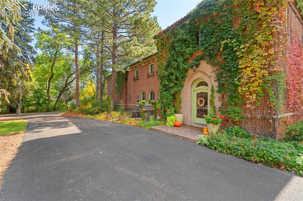 This historic Italian Renaissance manor is blocks from the famous Broadmoor Hotel and its five-star amenities. Architectural modifications of the renowned Temple Buell designed mansion has allowed it to be lovingly remodeled to appeal to current lifestyles and décor, with an entirely new kitchen, master suite, walls removed, floors restored, all bathrooms have been updated, new furnace, etc. The new blends seamlessly with the old. A granite fireplace is the focal point of the living room which is lined with arched windows. The library, originally a solarium, features Honduran mahogany millwork throughout. Archways, arched windows, carved moldings, volume ceilings and custom wrought iron railings make this property a one-of-a-kind estate perfectly situated in the Old Broadmoor community.  There are many great outdoor living spaces, and verandas off several rooms. The brick exterior is set in thick rose mortar and is double walled and trimmed in granite of local origin. Van Briggle ceramic tile accentuates the chimneys. A/C on upper level.