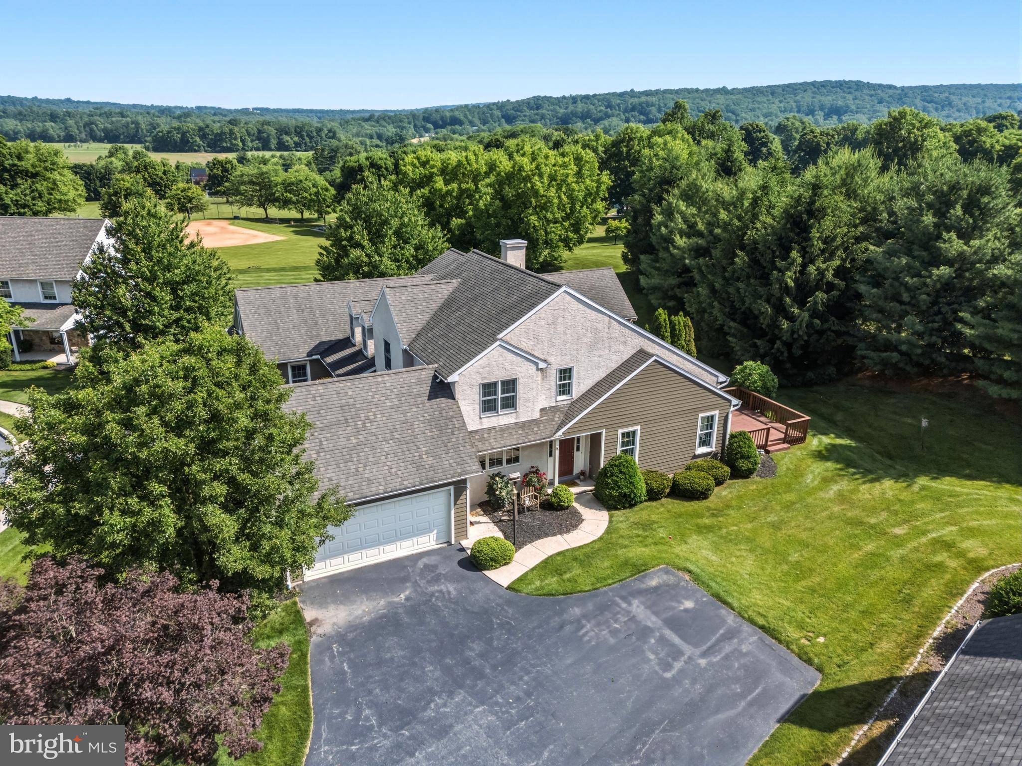 Built with craftsmanship by Stoltzfus Enterprises, the home features beautiful hardwood flooring throughout the main level and a striking vaulted great room that opens to a private deck, perfect for relaxation or hosting guests. The bright, spacious dining room boasts lovely views and provides an excellent setting for entertaining family and friends. Upstairs, an overlook and convenient office nook complement two additional bedrooms and a full hall bath. The finished lower level provides a spacious recreation room—ideal for a home theater, gym, playroom, or extra living area. Nestled in a picturesque and secure neighborhood, this residence offers the ideal blend of comfort and convenience—just a short walk from Livingood Park. This lovingly cared-for home offers low-maintenance living with elegant finishes and a newer geothermal heating system.