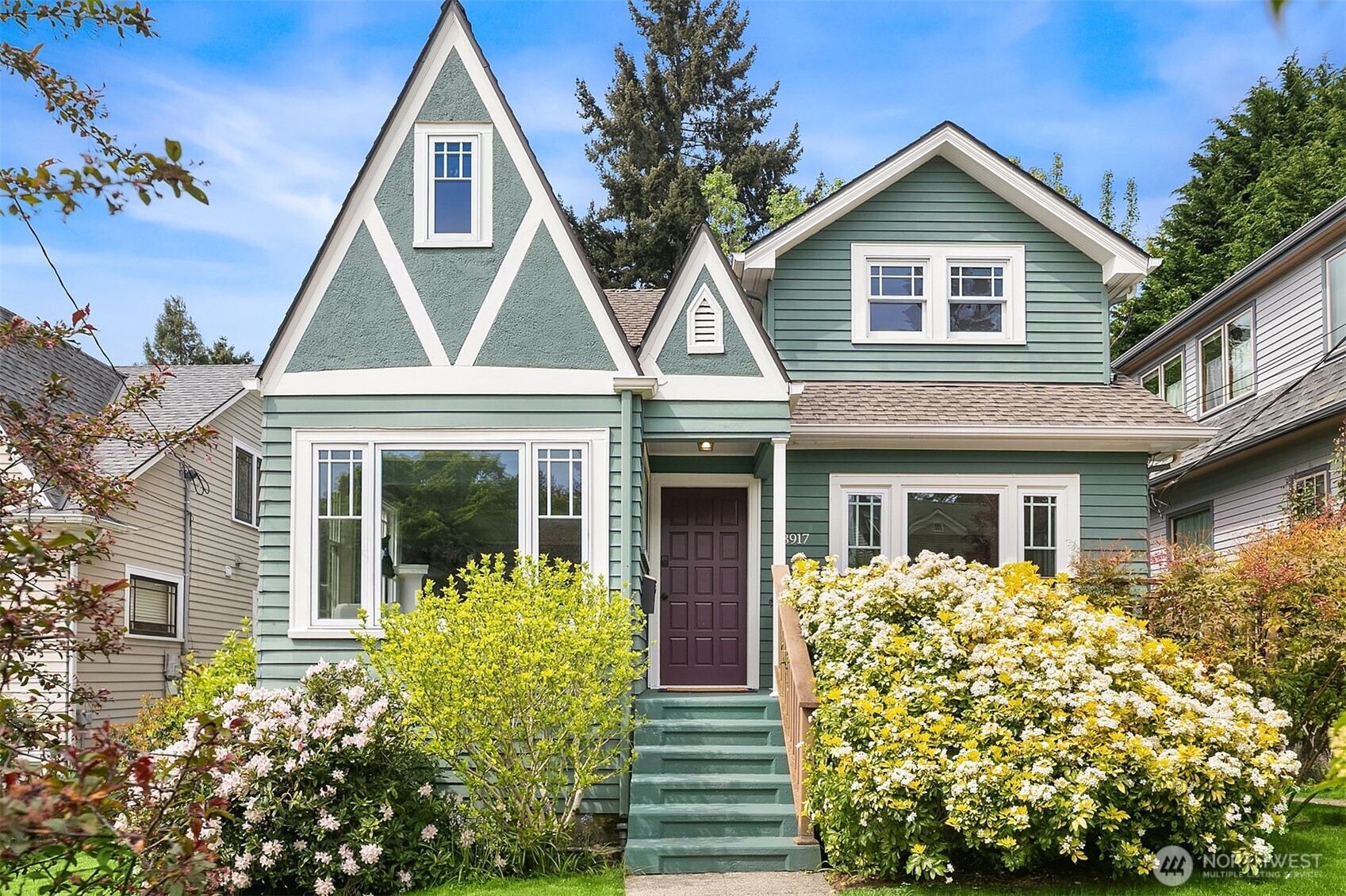 Don't miss this charming 1926 Craftsman located in one of Seattle's most coveted neighborhoods. As you enter, take in the period built-ins and light fixtures, decorative trim, cozy gas fireplace and bright, sunny spaces. From the updated kitchen, head through the Dutch door to the entertainment sized deck where you can catch a glimpse of the Space Needle. Upstairs, the bedrooms, darling nook, and full bathroom are all adorned in gorgeous clear fir, bringing a decidedly northwest feel to the spaces. Downstairs, the daylight basement is a fully permitted ADU with a bedroom, kitchen, office and full bathroom. Rent it out for supplemental income, or just enjoy it as a separate home office, guest quarters, or extra living space for you and yours. Two off-street parking spots and a generous lot with mature plantings provide plenty of room to roam. This home is just a stone's throw from downtown Seattle, Wallingford, Fremont, Lake Union, the Burke Gilman Trail, and the UW with a Walk Score of 93!