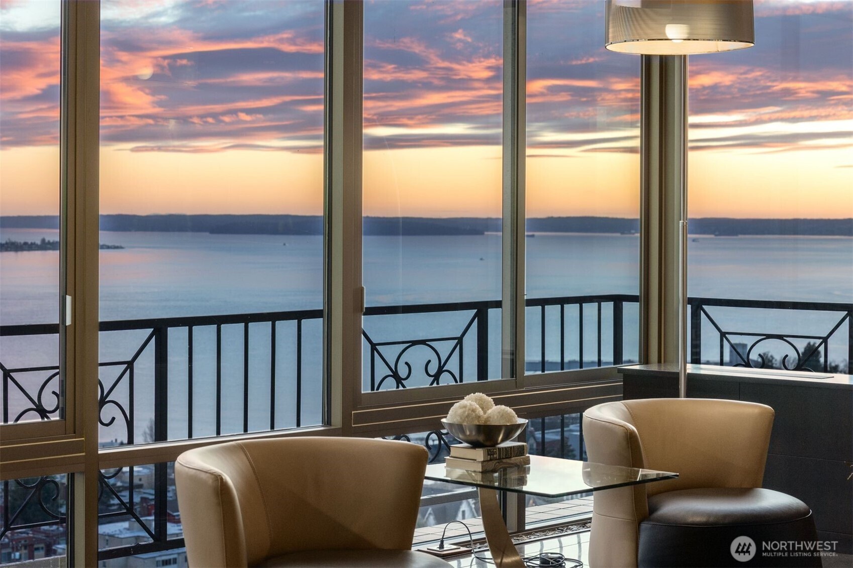 This extraordinary home is one of a kind, w/arguably the best sweeping views in Seattle! Own the entire top floor of this well known boutique building on famed W Highland Dr. It was completely re-imagined & reconstructed in 2016. Floor to ceiling windows & doors along entire South side, expertly bring the entire City into your home. Unobstructed panoramic views of Seattle, Mtns & Puget Sound surround you. Sleek modern design pairs w/warm rich woods & surfaces. Artfully designed chef's kitchen w/ custom cabinets, honed granite counters, top of the line appliances. Perfect entertainer's space & gracious open floor plan living. Gorgeous Primary Suite, + 2 more en-suite bdrms, 2 dens & media. 1st floor studio 4 sale with its own secure parking.