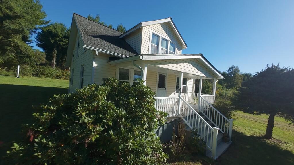 This is your chance to own a small piece of the slow pace, affordable living, and mountain beauty of the Blue Ridge Parkway town of Meadows of Dan, VA.  Home of the famous Mabry Mill, many wineries, the ultra-luxury 5-star Primland Resort, and growing Amish country.   Check out this 1930's bungalow style home on over an acre just 2 miles from downtown Meadows of Dan and the Blue Ridge Parkway.  The home is 1,109 square feet with 3 bedrooms upstairs, an eat-in kitchen, full bath, living room and additional room the Seller used as the main floor bedroom.  Original hardwood flooring in the 2 main living areas and newer laminate flooring throughout the upstairs bedrooms and main floor kitchen.  A large covered front porch for enjoying the view and fields across the street.  The property has a separate chicken coop, plus a barn area for additional chickens, goats or other animals behind the garage.  There is a large fenced garden area for growing your own vegetables and another separate shed for storage.  The house has its own well and septic and the old spring house is attached to the main house and has become the laundry hook-up room.  There is a lot of old charm with this place and a good opportunity for someone wanting to do some Homesteading.  The roof and well were replaced in 2011. This will not qualify for a VA loan due to ceiling height of some rooms and narrow/steep stairway,  The home is offered "As-Is" but buyers are welcome to have a home inspection for information purposes.