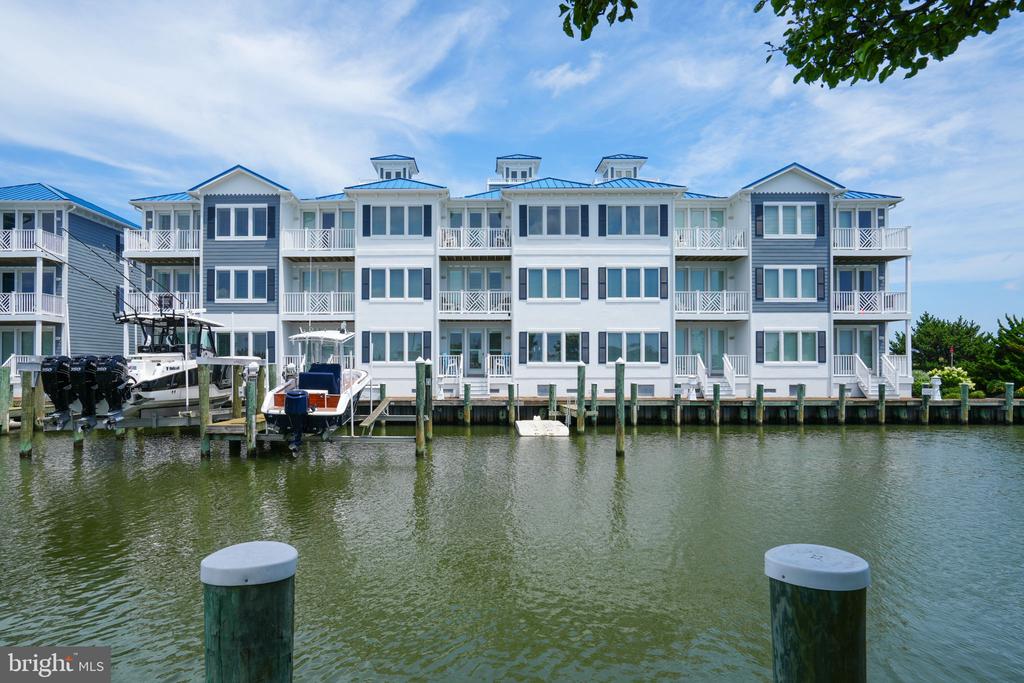 This luxury coastal home in West Ocean City with views of the inlet and marina has just been listed. This is a very unique opportunity to own this 3069 sq. ft townhome, with elevator, in sought after Inlet Isle. This beautiful townhome would make a perfect second home or primary residence. This home has ALL the latest finishes and upgrades. The home is complete with Plantation shutters for all windows. The first level has one of the home's two family rooms which could also be used as a game room, home office or fourth bedroom.   It has a gas fireplace, full bath and custom shower. The first level also has a deck which leads to the pier and boat slip.   The laundry room is also conveniently located on this floor. Take the stairs or the elevator to the second floor, where you will find a luxurious primary bedroom suite overlooking the water with en suite bathroom complete with heated floors, steam shower and soaking tub.  Also, the primary suite offers his and hers walk-in closets. On the second level there's also another bedroom with en suite bath with shower and walk-in closet. Continue by way of the stairs or elevator to the third level, where you will find a spacious family room with gas fireplace, dining area, upgraded kitchen with an abundance of cabinets, granite countertops, stainless steel appliances, a wine refrigerator and breakfast bar.  There is also a wet bar next to the fireplace with built in shelving on the other side. This floor also has another bedroom with full bath with shower and walk-in closet.  Both the second and third floor decks have stunning views of Ocean City.   There is a deck off of this family room that overlooks the marina and has fabulous sunset views. For even more beautiful views take the spiral staircase up to the crow's nest on the rooftop and enjoy the sights of Ocean City.  It is close to the inlet, restaurants, shopping, water sports, the Ocean City beach and boardwalk. It is also in the perfect location to watch the fireworks and the boats in the inlet and marina.  This unit is fully furnished, just bring your bathing suit and your toothbrush.  It is beautifully decorated and furnished.  The oversized boat slip and lift that will accommodate a 38-foot boat with a weight capacity of 25,000lbs.Listing Office