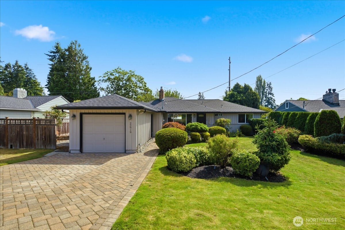 Welcome to this beautifully, maintained Ray Anderson built Edmonds rambler offering easy, single-level living in a fantastic location.  This 3 bedroom home features a bright and inviting living room with a cozy fireplace that is shared with the spacious family room and an open flow to the dining area. The updated kitchen offers granite countertops, customized pull out drawers, ample storage and stainless steel appliances-perfect for everyday living. The home includes an updated 3/4 shower, a convenient 1/2 bath off the kitchen, comfortable size bedrooms with great natural light. Original oak hardwood floors, updated lighting, A/C makes this home comfortable in any season. Private and fully fenced yard with mature landscaping, raised beds and an apple tree- ideal for relaxing, gardening or entertaining. Set back from the street for added privacy, this home features a beautifully maintained front yard, an attached garage, and plenty of additional parking. Close to hospitals, parks, golf, interurben trail, stores and freeway. Welcome home