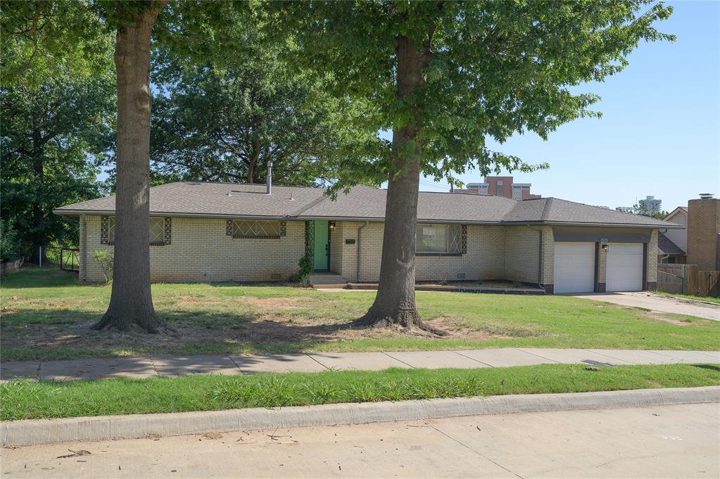 Affordable, remodeled, beautiful contemporary mid-century on 1/3 acre.  This is it.  Stunning contemporary interior with updated kitchen and baths.  Kitchen is beautifully designed with designer ceramic tile, premium stainless appliances, amazing light fixtures and hardware--all in keeping with the contemporary lines of the home.  Open floor plan with kitchen, living and dining all open to one another.  Baths have new fixtures and hardware and tile.  Solid surface flooring thru out.  Huge fenced 1/3 acre lot with a very large unfinished storage building/apartment in the backyard.  Landscaping was artistically choosen to reflect the mid-century style of the home.