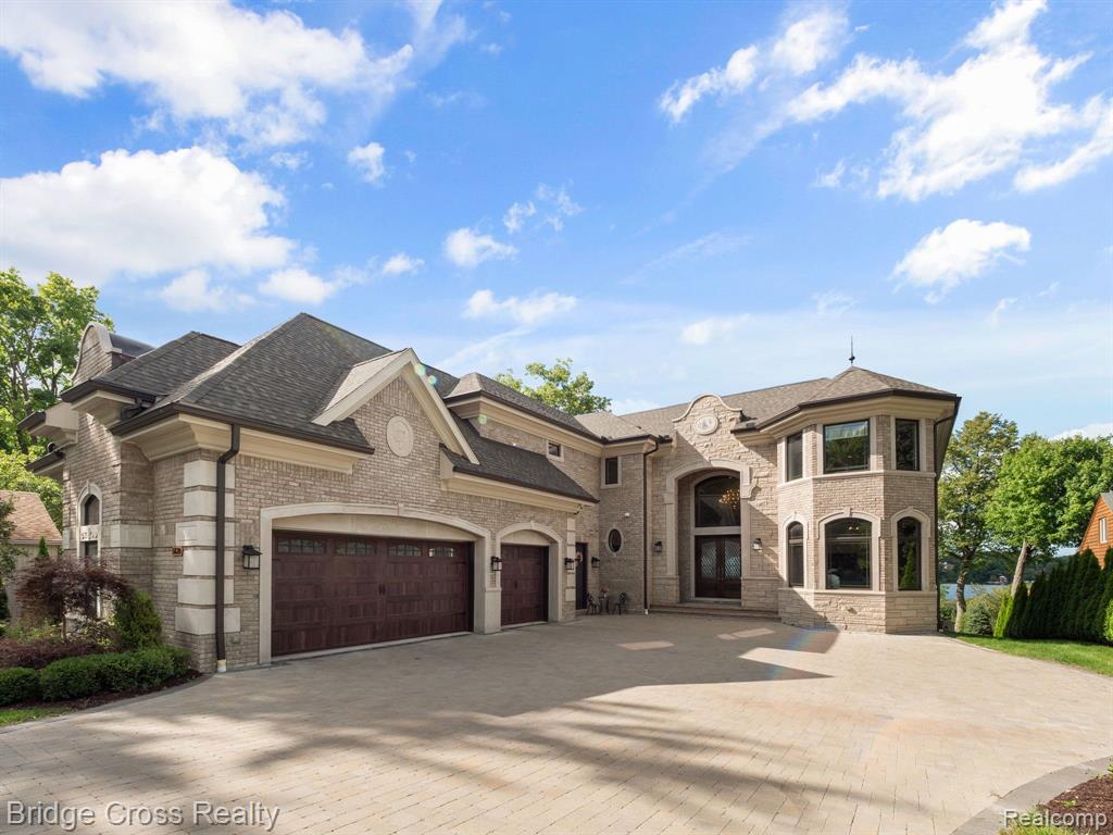 ***REDUCED $351,00 IN THE LAST 6 MONTHS*** Experience unparalleled luxury in this stunning 8,500 sq. ft. waterfront estate on all-sports Upper Straits Lake in Orchard Lake, Michigan. This exceptional 4-bedroom, 5 full-bath, 3 half-bath mansion boasts 80 feet of pristine lake frontage on a double lot with breathtaking views. Step inside to soaring 20-foot ceilings, heated floors, and three grand fireplaces. The gourmet kitchen is a chef’s dream, featuring top-of-the-line Thermador appliances, a Sub-Zero refrigerator, and exquisite finishes. A private elevator offers effortless access to all levels. The lower level is designed for entertaining, complete with an oversized walkout terrace, kitchen, fireplace, and a retractable projector screen. The 3.5-car heated garage provides ample space for vehicles and storage. This estate also comes equipped with a whole house generator. Indulge in lakeside living with this rare opportunity to own a masterpiece of craftsmanship and design.