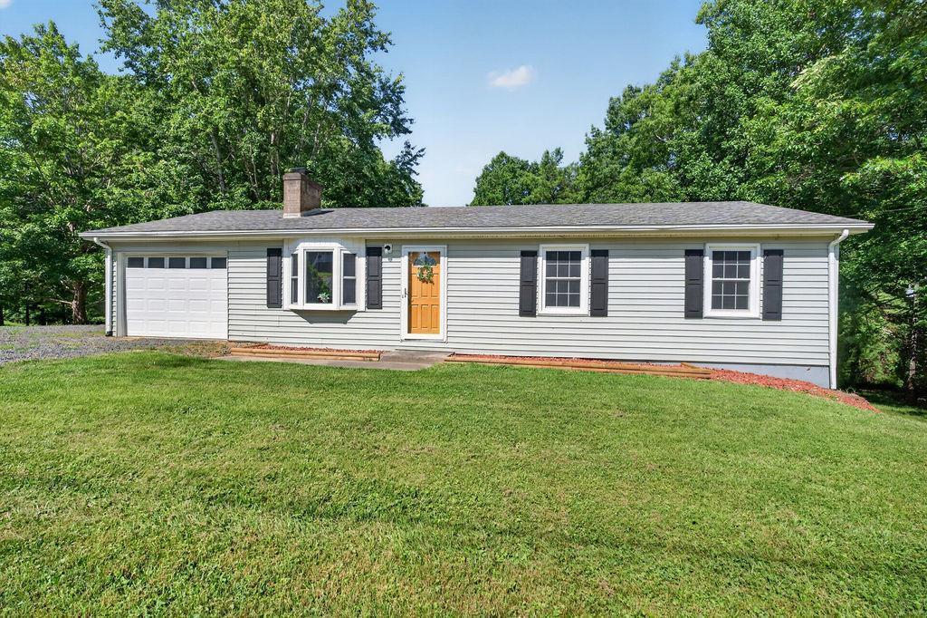 Looking for a move-in ready single level home with a little over 2.5 acres? This is it! Lovingly cared for by the same family for several decades, this beautiful home offers 3 bedrooms, 1.5 bathrooms, and over 1,500 square feet with spacious rooms and a layout designed for comfortable everyday living. Step inside to find fresh paint and beautiful flooring that make this home truly move-in ready. The highlight of the home is the stunning family room with vaulted ceilings, creating a bright, open space that overlooks the peaceful backyard, perfect for relaxing or entertaining. The attached one-car garage offers convenient access directly into the kitchen, while the matching detached garage/workshop located behind the home provides the perfect space for hobbies, storage, or additional workspace. Situated on just over 2.5 acres, you'll have plenty of room to enjoy the outdoors while still being conveniently located between Galax and Hillsville, & just minutes from Interstate 77. If you've been searching for a well-maintained home with acreage, spacious living areas, and a fantastic location, you won't want to miss this one!