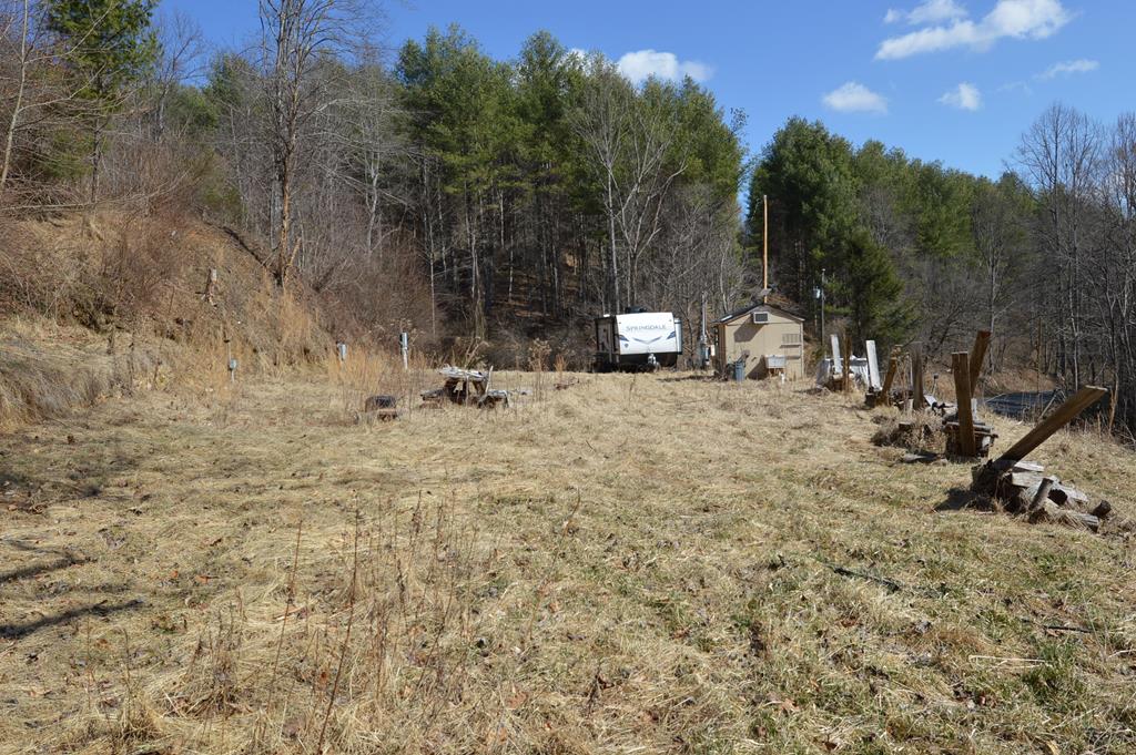 If you are looking for a Mountain get-away, this is it!  Nice Wooded 10 ac+/- tucked in the Mountains of Southwest Virginia.  Property has 3 hookups for Campers or Motorhomes.  There's a Bathhouse with Washer/Dryer, a Bunkhouse, and a drive thru Barn .  Roads are cut throughout the property and are great for hiking or 4-wheeling.  There's a stream on the property and a nice stream across the road that babbles all year long.  Lot's of Deer & Turkey, perfect for a Hunt Camp.  This is a perfect setting for your dream get-away in the Mountains.  Take a look today!