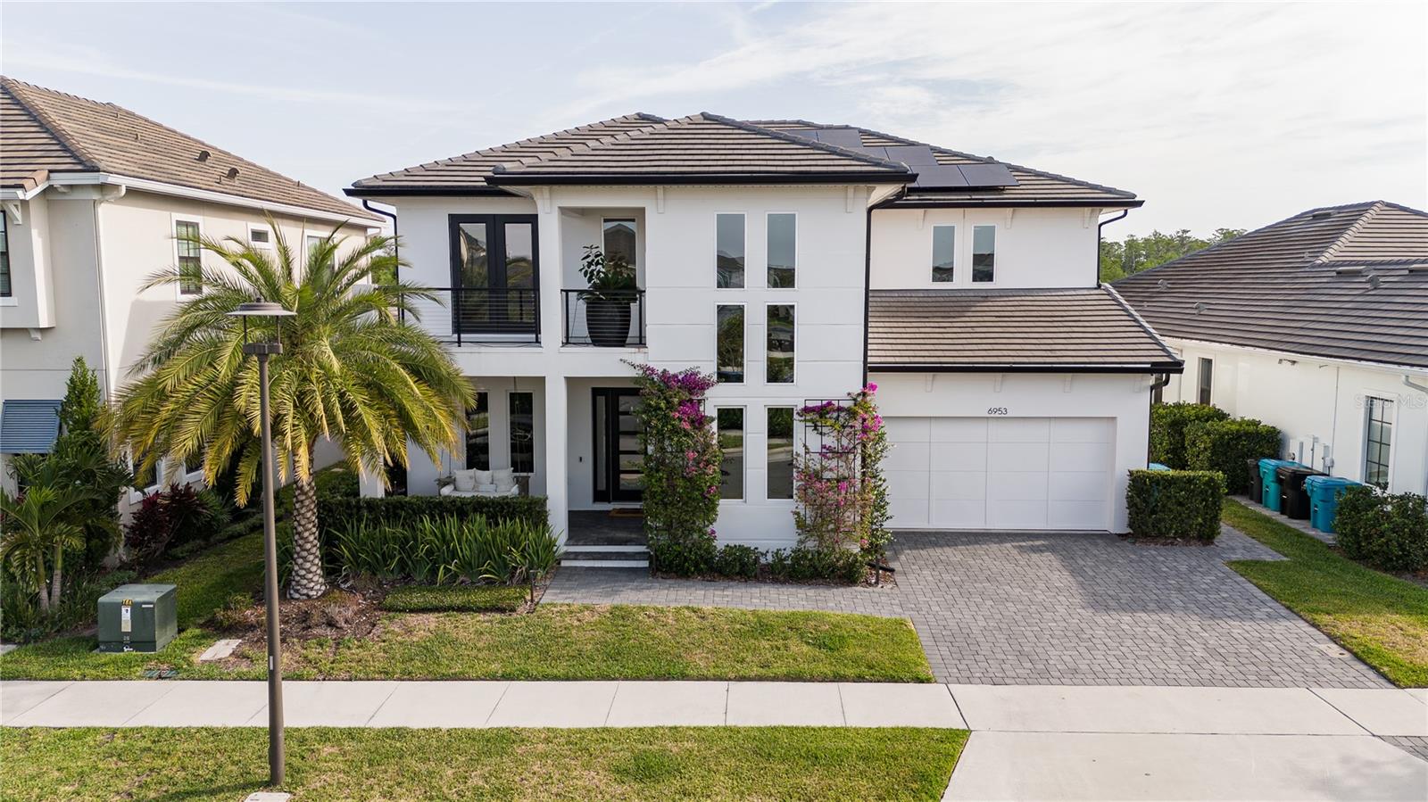 Get ready to fall in love with this incredible 4-bedroom, 3.5-bathroom home located in the heart of Laureate Park, Lake Nona’s premier community known for its lifestyle, location, and luxury. From the moment you pull into the extended driveway and take in the home’s striking curb appeal, it’s clear this one is something special. Perfectly situated on an oversized 8,840 sq. ft. lot, this home features thoughtful upgrades throughout, from professionally sealed pavers and a hidden trash enclosure to custom landscape lighting and built-in holiday lights ready for every season. The design is as functional as it is beautiful, offering the perfect balance between upscale living and everyday comfort. Inside, the open-concept floorplan is filled with natural light, soaring ceilings, and plenty of space to gather and unwind. A dedicated office sits just off the main living area and offers tall windows and a sense of airiness that makes working from home feel effortless. The chef’s kitchen is a dream, complete with Monogram appliances, a smart touchscreen fridge with hot water dispenser, a professional-grade cooktop, and a whole-house water filtration system with an added alkaline filter. The laundry area is just as impressive, featuring an additional high-end refrigerator, an LG washer with a built-in express mini-washer, and a premium dryer. Upstairs, the luxury vinyl flooring adds warmth and style, while the upgraded staircase and modern light fixtures elevate the entire space. The primary suite is a true retreat, with a large walk-in closet and a spa-inspired en-suite bath featuring dual vanities, a soaking tub, and a sleek frameless glass shower. Comfort meets practicality with dual-zone A/C systems, one for each floor, an energy-efficient water heater, and a hardwired security camera system with full recording capabilities. A touchless ceramic kitchen faucet, smart irrigation system, custom bamboo landscaping for added privacy, and brand-new backyard fencing all contribute to the home’s thoughtful and efficient design. Step outside into your private outdoor sanctuary, an entertainer’s paradise. The saltwater pool is surrounded by heat-resistant decking, while the covered pergola houses a full summer kitchen outfitted with a built-in beverage fridge, trash drawer, a smokeless touchscreen air grill, and a modern waterfall feature, all fully controlled from your smartphone. Premium synthetic turf, a four-hole putting green, designer patio furniture, and a cozy swing add the perfect finishing touches to this one-of-a-kind backyard escape. Whether you're heading to the neighborhood coffee shop, park, or community events, you can ride in comfort and style. To top it all off, the home is equipped with a cutting-edge solar panel system, providing significant energy savings and a more sustainable lifestyle. All of this is just minutes away from Lake Nona’s top-rated schools, medical facilities, shopping, dining, and some of Orlando’s best parks and entertainment. This home isn’t just a place to live, it’s a lifestyle. Schedule your private showing today and don’t miss out on everything this incredible property has to offer!