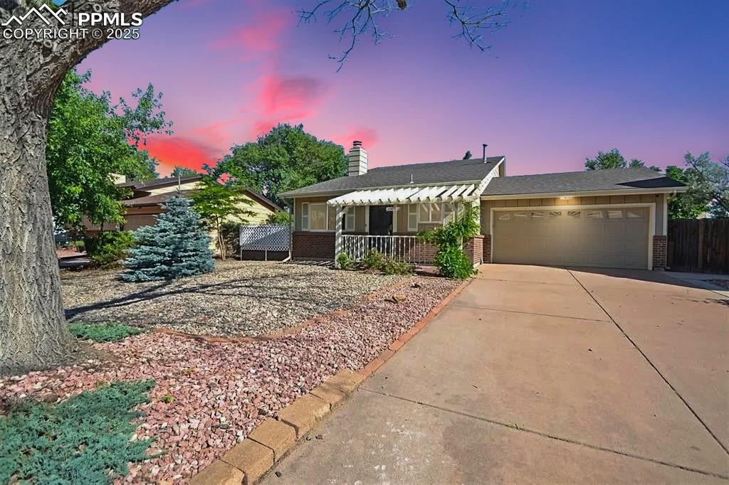 This charming home is a perfect blend of comfort and convenience. It features two spacious bedrooms and two bathrooms, each thoughtfully updated with high-quality tile, new paint, and modern fixtures. The main and upper levels showcase new interior paint throughout and well-maintained wood plank flooring, adding warmth and character to the space. The living room is bright and inviting, with vaulted ceilings, track lighting, and a cozy wood-burning fireplace. It opens onto a west-facing lattice deck that leads to a generously sized backyard, making it ideal for outdoor entertaining. The kitchen is equipped with stainless steel appliances and flows seamlessly into the open-concept dining area. The backyard is further enhanced with a beautiful pergola, creating a serene space for relaxation or gatherings. The home also offers practical features, including a two-car garage, ample attic storage, and forced air heating for winter and central air conditioning for summer, ensuring year-round comfort. Located in a highly convenient area, this home is close to schools, public transit, shopping centers, restaurants, and more. Plus, it offers easy access to military bases like Fort Carson and Peterson Air Force Base. This property is a perfect blend of functionality, style, and location! Be sure to check out the virtual tour and then schedule your showing.