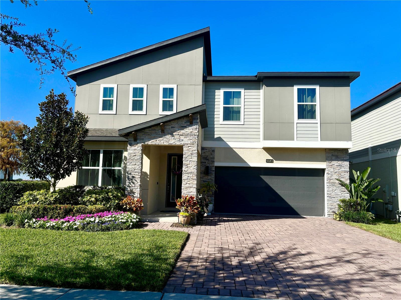 Stunning Lakeview 5-Bedroom Home in the Heart of Orlando- Sand Lake Sound. Experience modern elegance and breathtaking lake views in this 5-bedroom, 4-bathroom home located in the heart of Orlando. The main floor features one bedroom with a full bath, while the upstairs boasts a luxurious master suite along with three spacious guest bedrooms and a large loft—ideal for a game room, media center, or second living space.  Luxury vinyl flooring flows throughout the entire home. The stunning gourmet kitchen boasts sleek stainless steel appliances, elegant quartz countertops, ample cabinetry and modern lighting create both functionality and style. Relax on your screened-in patio and take in the panoramic view of the expansive sand lake. The home is perfectly positioned next to the community dock—offering peaceful sunsets—and directly across from the resort-style community pool.The lakefront community of Sand Lake Sound, nestled between Big and Little Sand Lake, enjoy convenient access to popular shopping, dining, and entertainment. Walt Disney World, SeaWorld, Universal Orlando, and other popular Orlando area attractions are only a short drive away. Don’t miss out on this opportunity to own this stunning lakefront home—schedule your private tour today!