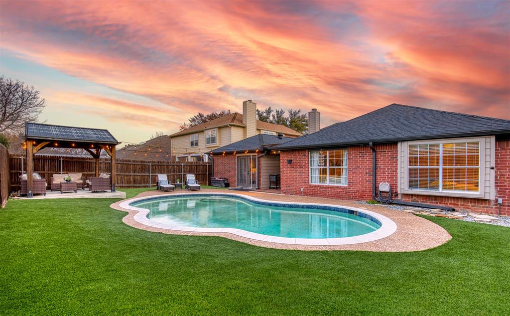 Welcome Home to this gorgeous one story home nestled in the heart of Flower Mound, Texas within minutes from Parker Square.  No HOA!  Featuring a backyard oasis with a sparkling pool, outdoor living and NEW luxury Turf.  This beautiful 3 bed, 2 bath home features an extra large bonus living area with pool access.  Incredible open and bright layout with a large living room with fireplace and built in shelving.  Kitchen features granite countertops, ample cabinet space, a breakfast bar, and a generously sized eat-in area. The large owner's suite overlooks the pool and backyard oasis featuring an ensuite bathroom with dual sinks, a garden tub, separate shower that has been recently updated, and a great sized walk-in closet. Don't miss touring this beautifully updated home with an excellent layout and very conveniently located just a short drive from all major highways and an easy short 15 minute commute from DFW Airport and walking distance of the recently renovated Possum Park! Recently updates, New Turf in backyard 2025, HVAC 2022, Pool Pump and Dishwasher 2023, and significant upgrades Class 4 Roof, Gutters, and Exterior Paint 2024.