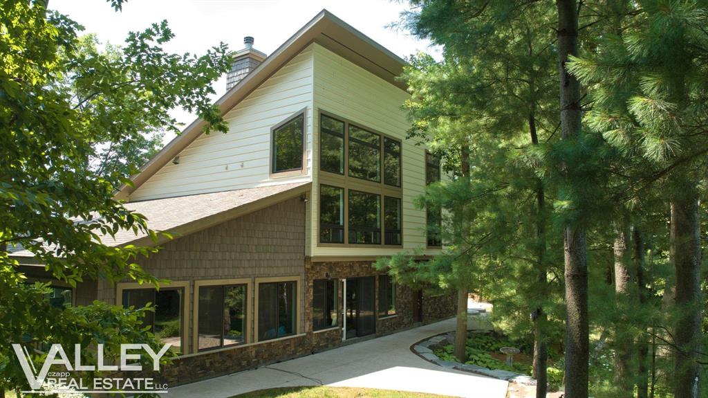 Welcome to your own private Paradise where luxury and nature are intertwined!! This 3 bedroom, 3 bath custom built home is located in Freeland and is situated on 11 pristine acres! this property is not just a house "“ it's a lifestyle with the 2 ponds, beautiful and well-maintained grounds, a 72'x45' heated pole barn with an additional attached 30' x 30' space for added storage, office, etc. and wooded acres with walking trails!  As you enter, you'll be impressed by the 3 car heated attached garage and will be even more impressed when you step into the recreation room with full bath, which leads to the indoor pool room. You'll feel like you're out in nature while floating in the warm pool with panoramic views of the pond and woods watching the wildlife. The quality in this home is evident as you ascend the solid natural hickory wood stairs into the living room and get a glimpse of the breathtakingly beautiful floor to ceiling stone fireplace, amazing, reclaimed barn wood flooring and huge picture windows overlooking the ponds and woods.  This room opens seamlessly to the eat-in kitchen with its beautiful granite countertops, high-end appliances, pantry and built-in rough sawn wood table.  Retreat to the luxurious Primary suite, a generous 380 sq. ft. haven of tranquility. The en-suite bathroom is a spa-like oasis, featuring dual vanities, a luxurious walk-in shower, and designer fixtures that exude opulence. This is more than a home; it's where your aspirations meet reality, where every day feels like a retreat, and where lasting memories are waiting to be made. Welcome to your future.  Copy and paste the url below to see and share the video for this listing:  https://360-photography.aryeo.com/videos/01987f26-28ed-725a-990e-03f12d8ea240