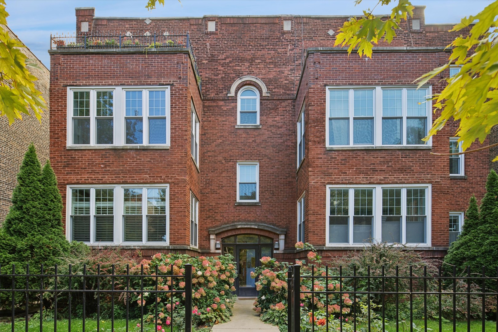 Step into a world of vintage charm and natural light in this high first-floor Ravenswood condo that blends character with comfort. The oversized living room welcomes you with rich hardwood floors, crown molding, and a classic white brick fireplace flanked by built-in shelving - perfect for displaying your favorite books or curated treasures.  Beyond the living space, a sunroom bathed in morning light offers endless potential: a peaceful home office, yoga nook, or your new favorite reading retreat. The layout offers room to breathe, with two bedrooms, a formal separate dining room for hosting, and an updated kitchen featuring white cabinetry, stainless appliances, and a soft tile backsplash that adds texture and polish.  The bathroom evokes spa-like calm with serene green tile and brushed fixtures, and the in-unit laundry and spacious back patio make everyday living easy. Tucked on a tree-lined block, you're just moments from Lincoln Square's indie shops, Rockwell's neighborhood taverns, and the Brown Line for an effortless commute.  Whether you're enjoying farmers market mornings or wine on the patio at golden hour, this home is an invitation to live beautifully in one of Chicago's most charming neighborhoods.