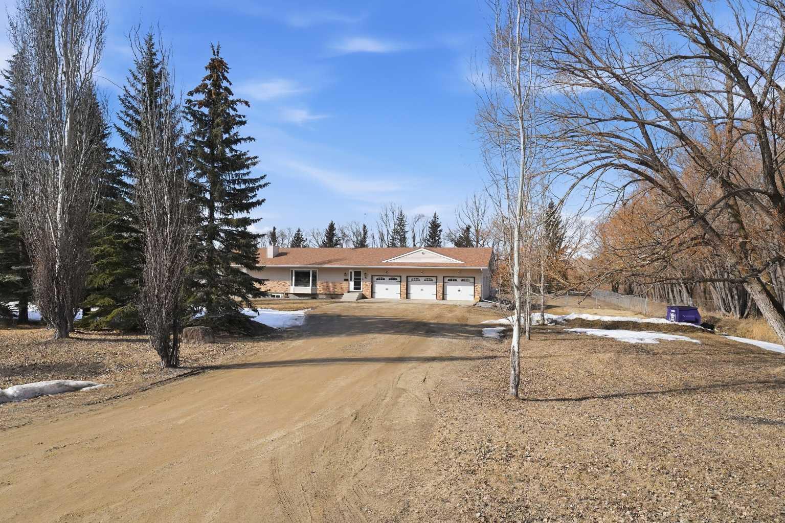 Beautifully updated 1990 bungalow on 1.9 acres in a highly sought-after neighbourhood just minutes from town with direct access to the C & E Trail. This home offers 4 large bedrooms plus an office, new flooring throughout, a fully renovated quartz kitchen, fresh paint, and two upgraded bathrooms. New patio doors off both the kitchen and primary bedroom lead to an expanded deck with hot tub. Electrical panel updated in 2023. Rear yard is fenced, and a large parking pad has been added. A well-maintained acreage property in a prime location with excellent upgrades throughout. The list is long.... added an office, new flooring throughout, , new lighting,, fully fenced yard, partially covered deck, there is nothing to do to this amazing bungalow but move in and enjoy!