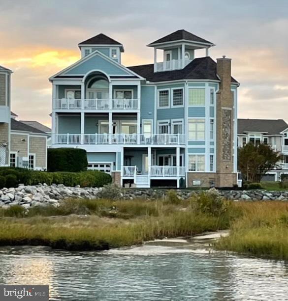 This luxurious home is Coastal living at its finest with breathtaking views of the bay, Assateague Island and the Ocean City skyline. This 6,000+ sq. ft. home is tucked away on a quiet cul-de-sac surrounded by other prestigious Coastal homes. This rare offering combines luxurious living with a waterfront lifestyle including a deeded deep water boat slip for a boat up to 35 ft.Welcome to your new Coastal dream home! There are 3 floors for a wonderful living experience. Entering the home, you will find yourself in a opulent foyer where you can go down a few steps to the first floor of the home. Here you will find 2 guests room and a full bath, a living room with a fireplace, deck with a bay view and The Captain's Quarters. This is a unique space that has it's own outside entrance, a full kitchen, full bath, laundry and opens into the hall as well. The foyer also takes you a few steps up to the main living area. This floor was designed for entertaining and for everyday living. Here you will find  a large  separate dining room with wainscoting and extensive windows for natural light. This carries into the butler's pantry and then to the gourmet kitchen which has stainless steel appliances, granite countertops extensive custom cabinets pantry and a large island with seating. For easy dining and entertaining, the dining area is between the kitchen and living room. and opens onto a large deck with direct water views. this area flows into the living area with a wet bar, stone fireplace and extensive windows providing water views and plenty of light.   Tucked next to this area is a den which offers quiet and privacy when a bit of rest is needed. The third floor is an owners retreat with fabulous views.  Featuring a bedroom suite with a sitting area, fireplace, 3 walk in closets,  a large bath with  double vanities, jetted tub, tiled stall shower and a water closet.  There is also an additional bedroom on this floor which is being used as a custom closet but can be easily restored to a fifth bedroom. You will also find a utility room for a place to make your morning coffee or prepare a snack, If you are looking for incredible views, continue up the spiral staircase to the Coastal Overlook.Every inch of this home is thoughtfully designed and upgraded with refined finishes offering both elegance and comfort.. The hardwood floor and tile throughout the home are a perfect example. An elevator provides effortless access to all 3 floors. Seapointe offers a marina, community clubhouse and a pool with reasonable HOA fees. You must visit this outstanding property, today. It is your next dream home with incredible views!