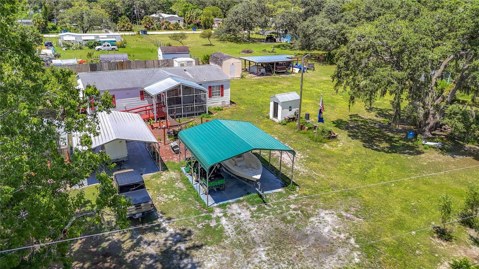 Great Opportunity - BACK ON THE MARKET! – This offering includes .45 acres with the home and a deep 70+ foot well, fully fenced and tucked away on a peaceful, lightly traveled road bordered by greenbelt on one side and homes on the other. Zoned AR (Agricultural/Residential), the property offers flexibility for licensed bee hives, small-scale agriculture, and more. Step onto the land and you’ll find thoughtful improvements, including two oversized carports—one large enough to accommodate an RV, a boat, or multiple vehicles. A goldfish pond in the yard adds charm to the setting, while a chicken coop with hens producing over a dozen eggs a day offers fresh food right at your doorstep. Prefer city water? It’s already installed—just a quick call to the county gets it flowing. The home itself is designed for comfort and accessibility, featuring a wheelchair-accessible ramp, 36” doorways, and a walk-in tub for safety and ease. Inside, you’ll find nearly new vinyl plank flooring, newer windows, and a roof replaced just last year for long-term peace of mind. Additional upgrades include a professionally installed grey water system to reduce strain on the septic and cut maintenance costs for years to come. Location is another highlight—Veterans Memorial Park is less than half a mile away, with tennis courts, a community pool, and walking trails. The Cambridge School campus (Hudson High School)—serving elementary through high school—is within walking distance, all on one secure property. Whether you’re dreaming of a small homestead, a peaceful retreat, or simply a property with sustainable features and room to breathe, this Hudson gem offers unmatched versatility and value. And for the right offer, the owner may be willing to sell the adjoining .45-acre parcel as well—doubling your space and possibilities. Schedule your private tour today. Current road is lime rock but is scheduled to be paved by the county in early 2026.