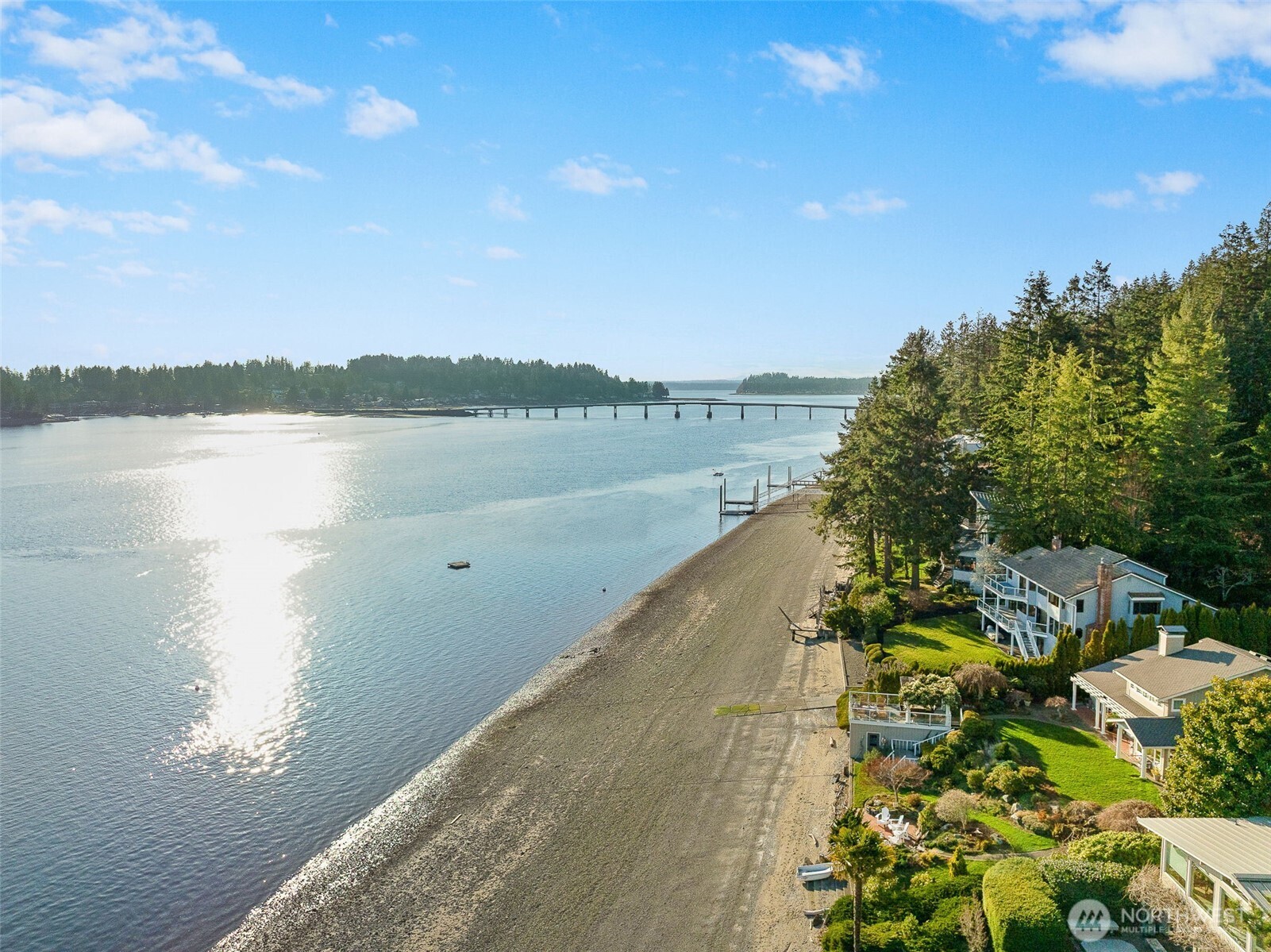 Very Rare Southern exposure, Low/No bank Legacy property on coveted Ford Drive, where life is truly "better at the beach". Wake to Mt. Rainier’s grandeur, spend sun-soaked days strolling the sandy shore of the area's best beach, & launch adventures from your own private boat ramp— that could never be built again today. Nearly every room of its quality, custom crafted 4600+ sf captures breathtaking views of Hale Passage, the Fox Island Lighthouse, glorious sunrises & fiery sunsets as Rainier glows in the east. With a 30 x 30 boat garage, 103 feet of frontage, moorage, and a lower-level apartment for all the guests, this timeless waterfront retreat offers a lifestyle few will ever experience.  Bring your dreams home just in time for summer!