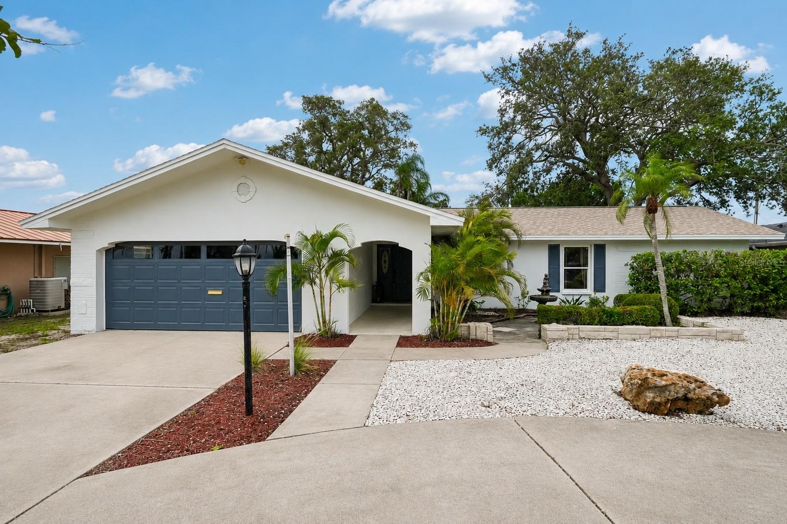 Perfectly positioned on over a quarter acre of land in one of Largo’s most convenient locations, this property offers the space, flexibility, and Florida lifestyle that is sought after. Situated in a non-flood zone with no HOA, you'll enjoy being just minutes from the sugar-white sands of our beautiful Gulf Coast Beaches.Set on a spacious lot, this beautifully maintained 3 bedroom, 2 bathroom, 2 car garage pool home offers nearly 1,700 square feet of living space and has been thoughtfully updated over the years. Recent improvements include a brand new roof in 2025, fresh interior and exterior paint, and brand new luxury vinyl plank flooring throughout.Stepping inside, the front living room flows seamlessly into the dining room located just off the kitchen, creating an inviting layout for everyday living and entertaining. The kitchen features granite countertops, stainless steel appliances, and a stylish backsplash. Just beyond the kitchen, the family room serves as a cozy gathering space centered around a beautiful stone-surround fireplace.The split bedroom floorplan offers privacy, with the owner's suite tucked away and featuring its own ensuite bathroom. Additional bedrooms and the second full bathroom are positioned on the opposite side of the home.A large sunroom spans the rear of the home and overlooks the expansive fenced backyard, creating the perfect space to relax year-round. Step outside and discover an entertainer's dream. The heated in-ground pool serves as the focal point of the backyard, complemented by a private basketball court, gazebo overlooking the pool area, and plenty of yard space for pets, play, and outdoor gatherings. Spend your weekends enjoying sunset walks along the Gulf at nearby Indian Rocks Beach, waterfront dining, local beach shops, boating, fishing, kayaking, and paddleboarding. With no HOA restrictions, ample outdoor space, and a location close to the beach without being in a flood zone, this property offers endless possibilities as a primary residence, seasonal retreat, or investment opportunity.