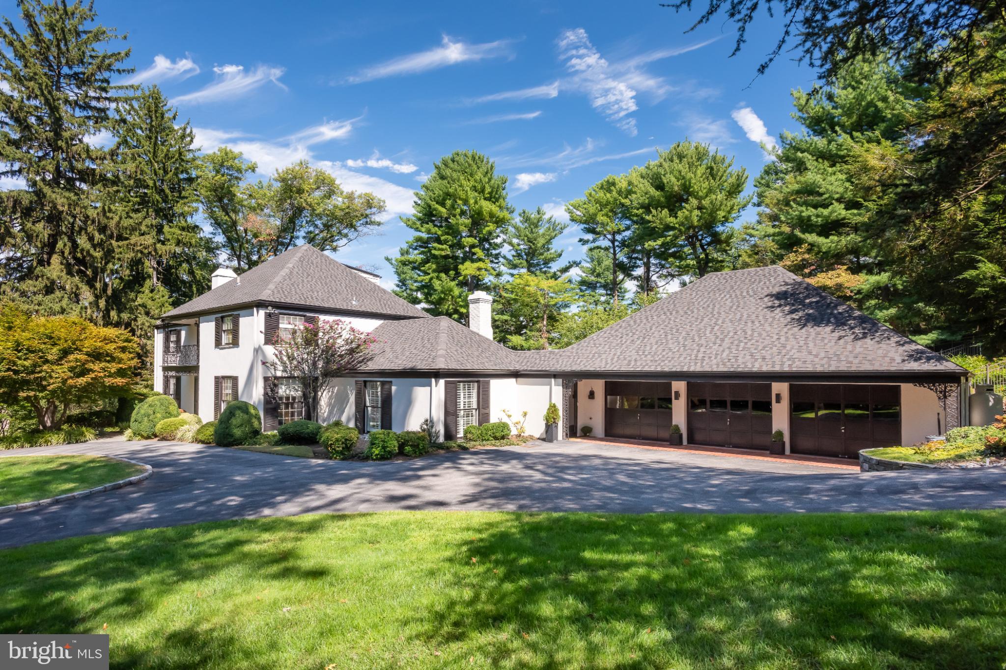 Nestled in a private cul-de-sac, this exquisite French Colonial style residence offers a luxurious lifestyle defined by elegance, privacy, and comfort in desirable Northside Villanova. This home is a true sanctuary, blending timeless architectural charm with modern amenities. A circular drive offers a gracious welcome to a house featuring sun-filled and open interiors boasting spaces for the entire family to gather together or to just find a place to call their own. The open floor plan seamlessly connects the gourmet kitchen, featuring upgraded countertops, stainless steel appliances, and a spacious island, to the family room, where exposed beams, recessed lighting, and a wet bar with built-ins create a warm and inviting atmosphere.  Enjoy casual meals in the breakfast area or entertain guests in the adjacent dining room, which opens to a large and sunny living room. A bonus on this level is an adjacent second family room with built-ins. This house can accommodate large-scale entertaining but also provides perfect spaces for quiet evenings at home. Both family rooms are bright and sunny with sliders to the large fieldstone patio and beautiful swimming pool. This private, outdoor oasis features extensive landscaping perfect for outdoor gatherings or quiet evenings under the stars. A new full bath and changing area provide convenience for both guests and family. The home boasts four generously sized bedrooms, each designed with comfort in mind. The primary suite is a true retreat, featuring his and hers en-suite bathrooms, a separate dressing room, and a Juliet balcony with views of the picturesque outdoor area. The third floor features a convenient office and plenty of storage. Venture to the lower level, where a finished, heated basement awaits, offering ample space for recreation or relaxation. This house has been meticulously maintained by the current owners, with a new roof installed in 2024, as just one example. Additional highlights include a three-car attached garage with ample storage and EV charger, geothermal energy, a generator, a new mudroom with a dedicated dog bath and energy-efficient double-pane windows that enhance the home's comfort and sustainability. Security features, including a comprehensive system and smoke detectors, provide peace of mind. This exceptional property is not just a home; it's a lifestyle. Experience the perfect blend of luxury, comfort, and tranquility in this stunning residence, where every detail has been thoughtfully curated to create a warm and inviting atmosphere. Conveniently located near major transportation, prime dining and shopping, and in award winning Lower Merion School District.