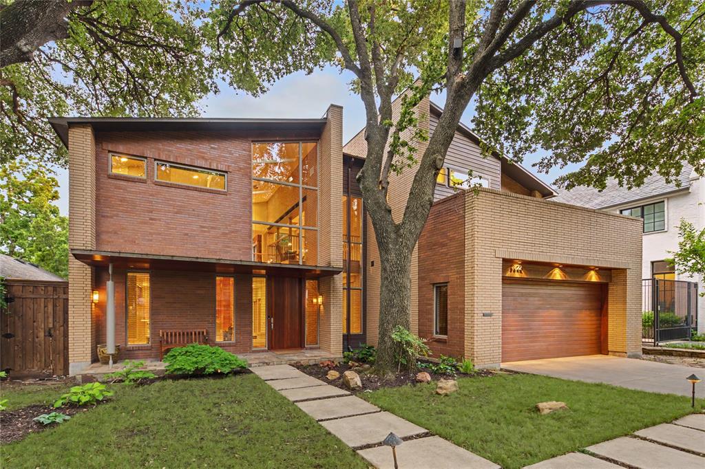Architectural masterpiece by Mark Domiteaux, inspired by Frank Lloyd Wright’s Meyer May house, this organic modern residence is a symphony of natural materials & thoughtful engineering. Artfully set into the terrain to cascade from front to back, utilizing a timeless palette of Douglas fir, slate, copper, and Norman size brick to emphasize its striking horizontal profile. The experience begins at the oversized front door, where a soaring foyer offers immediate views through the living area to a lush garden anchored by a decades old live oak tree. The interior aesthetics are defined by warm Douglas fir columns, granite surfaces accented with copper backsplashes, and a majestic Arkansas Gold stone fireplace that carries its natural coloration seamlessly from the living room to the adjacent outdoor patios. Extra deep hickory pecan steps with slate risers lead to the upper level, where a library area juts over the foyer to create a cozy bird’s nest retreat with access to private decks nestled within the tree canopy. Beyond its aesthetic brilliance, the home is designed with meticulous attention to functional luxury and longevity. Featuring two primary suites, with the lower suite offering independent heating, hot water, and laundry hookups, making it an ideal solution for guests or multi generational living. For the motor enthusiast, the four car garage serves as a hobbyist's sanctuary, equipped with industrial cooling fans, a transition mudroom, & custom flooring that pays homage to KTM motorcycles. Every detail was chosen for ease of use and durability, including granite and Corian sills designed to withstand sun exposure and stainless steel lateral beams over the patio for minimal maintenance. Abundant built in storage is found throughout, including custom cabinetry in the primary suite & butler’s pantry. This residence is a rare synthesis of high design pedigree & modern utility, complete with 220V electricity for a hot tub installation on the southwest stone patio.