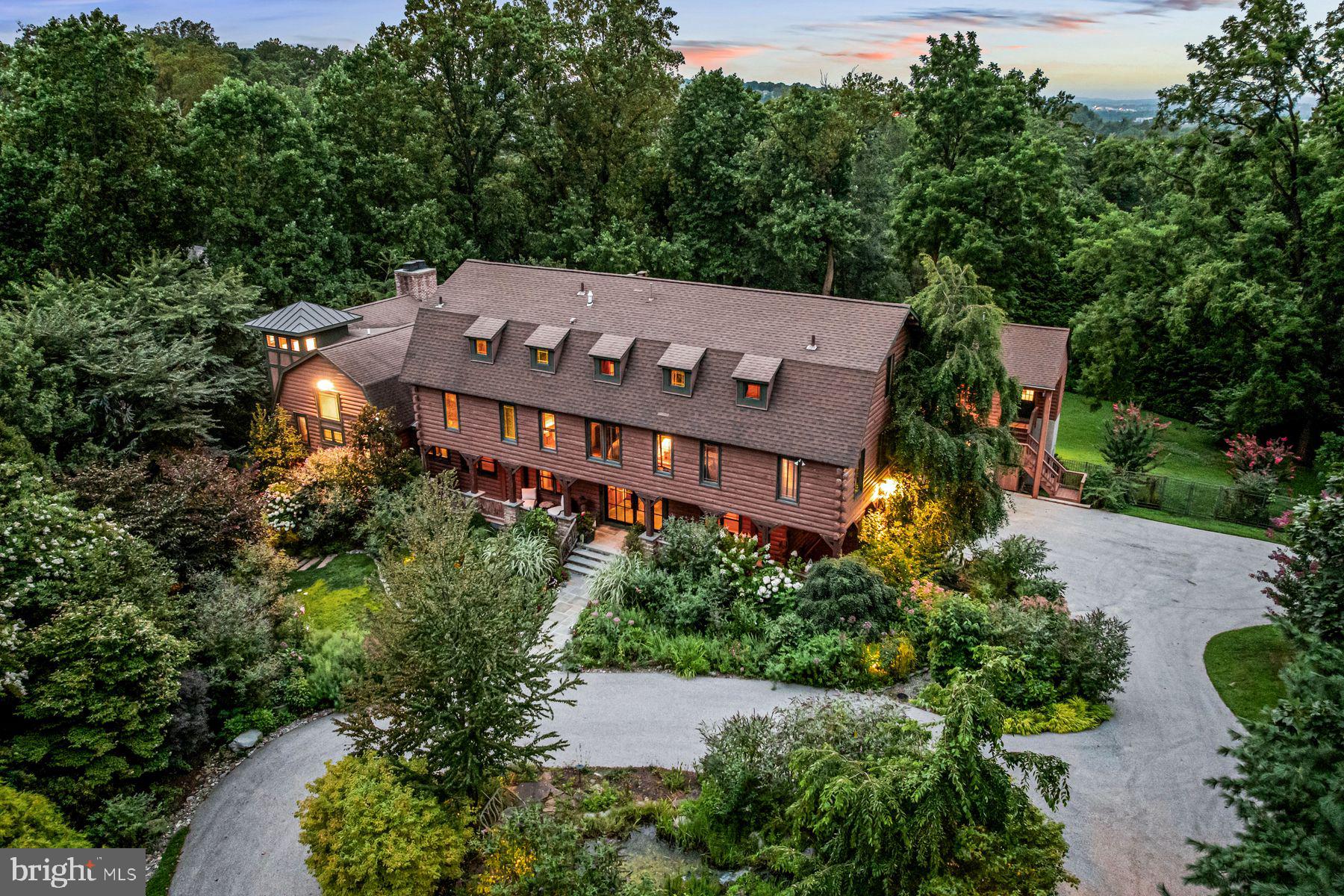 Look no further. This breathtaking, one-of-a-kind property offers artistically designed and meticulously crafted interior and exterior living spaces at every turn. Set on a private, beautifully landscaped 2.65-acre lot with saltwater pool in Villanova's estate section, this incredible converted barn offers a spectacular sun-filled open floor plan, easily integrating interior and exterior living spaces for a comfortable family lifestyle and effortless large or smaller scale entertaining. Endless features include an open foyer leading to a 2-story great room with oversized wood burning fireplace, wet bar, voluminous beamed ceilings with trusses, large windows , with glorious views, large glass cupola and reclaimed floors, fabulous gourmet natural cherry kitchen with soapstone countertops and professional appliances, adjacent dining area, sitting room and, prep kitchen, mudroom and access to 3 garage bays and a custom designed office with beautifully crafted built-ins. The first floor also includes a spacious primary suite wing with fabulous dressing room fully outfitted with custom cabinetry and built-ins, a luxurious, bright bedroom with fireplace, private balcony, his and hers marble baths with imported fixtures and second laundry room. The second floor offers 4 additional spacious bedrooms, 2 with ensuite baths and 2 with a Jack and Jill bath, perfect for kids or guests. The third-floor loft, with amazing views of the vast architectural beam structure, also features a 5th full bathroom and flexible living space as an expanded office, gym, studio and more. The walk-out lower level offers a custom designed theater, stunning, bright studio/ office space with a gas fireplace, full bathroom, recreational space and more. This is a rare find, close to renowned Lower Merion and Private schools, top Universities, endless recreational opportunities and clubs, all forms of transportation, world class dining and entertainment, Philadelphia, New York and more