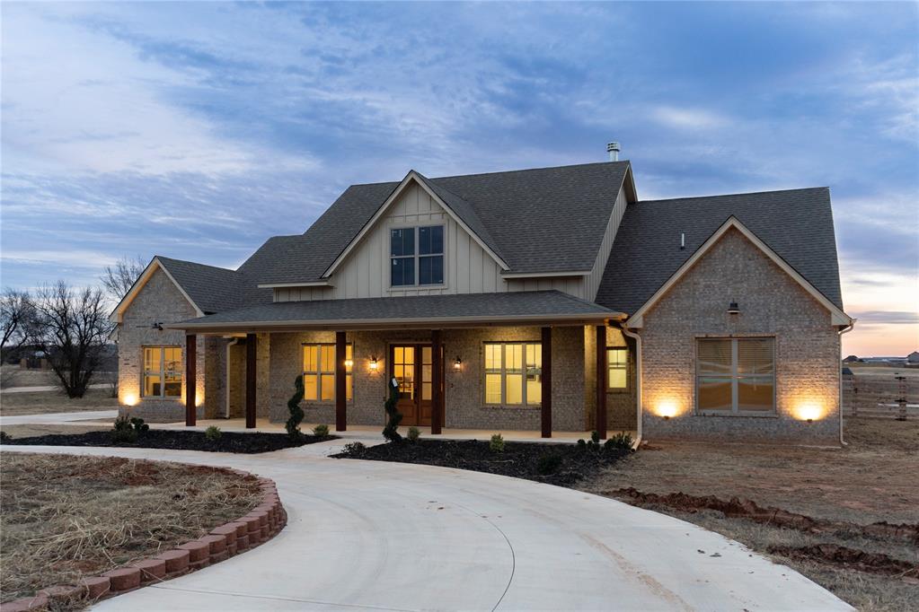 Experience modern luxury on over an acre in this newly built 4-bed, 3.5-bath home in the sought-after Edmond area. Thoughtfully crafted with a refined Craftsman/Modern Farmhouse aesthetic, this single-level residence offers 2,581 sq ft of elevated living, blending clean lines, warm textures, and high-end finishes throughout.Step inside to an open, light-filled layout where tall ceilings and expansive windows frame peaceful acreage views. The living room is anchored by a striking wood-burning fireplace—beautifully finished with stonework and a stained wood mantle—creating a welcoming focal point for gatherings. Luxury flooring flows seamlessly into the gourmet kitchen, featuring premium cabinetry, quartz surfaces, a spacious island, stainless steel appliances, and a walk-in pantry. The dining area sits perfectly between the kitchen and patio, offering effortless indoor-outdoor living.The private primary suite is a true retreat, complete with a spa-inspired bath showcasing an oversized walk-in shower, soaking tub, dual vanities, and a generous walk-in closet with built-in storage. Three additional bedrooms and well-appointed baths provide comfort and flexibility for family or guests. A dedicated half bath adds convenience, while the thoughtful split-plan layout enhances privacy.Set on 1.14 acres, this corner-lot property offers room to breathe with pastoral surroundings and a peaceful rural feel—yet you’re just minutes from Edmond amenities and within the desirable Deer Creek school area. Enjoy outdoor living on the covered patio, plus a 3-car garage for storage, hobbies, or extra parking.Ask how you could receive 1% of your loan amount back in lender credits—usable toward a rate buy-down, appraisal fees, or closing costs. Schedule your private showing today and experience the craftsmanship and comfort this exceptional home offers.