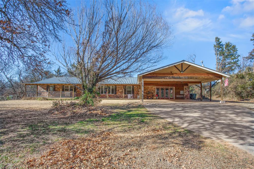 Escape to the country without leaving Edmond! This beautiful acreage just minutes from downtown Edmond features a charming ranch-style home with the front porch of your dreams. Enjoy peace of mind with updated plumbing, roof, windows, and A/C, plus invisible fencing around the entire property. Inside, you’ll love the updated kitchen and bathrooms, a functional mudroom, 2 living rooms, 2 dining rooms, and a cozy wood-burning fireplace. Step out back to the screened-in porch, perfect for relaxing year-round, and gather around the fire pit under the stars. Need space to work or store your toys? You’ll appreciate the 20x30 shop with electric and heat, plus two carports for extra covered parking. This one truly has it all!(SQFT is not correct, there is an additional 500sqft mol)All info to be verified by buyer.